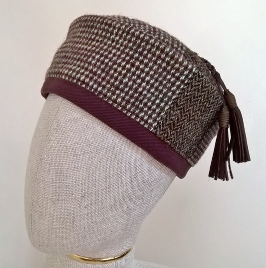 Harris Tweed wool smoking cap, in browns, cream and mauve shades, with leather tassel 