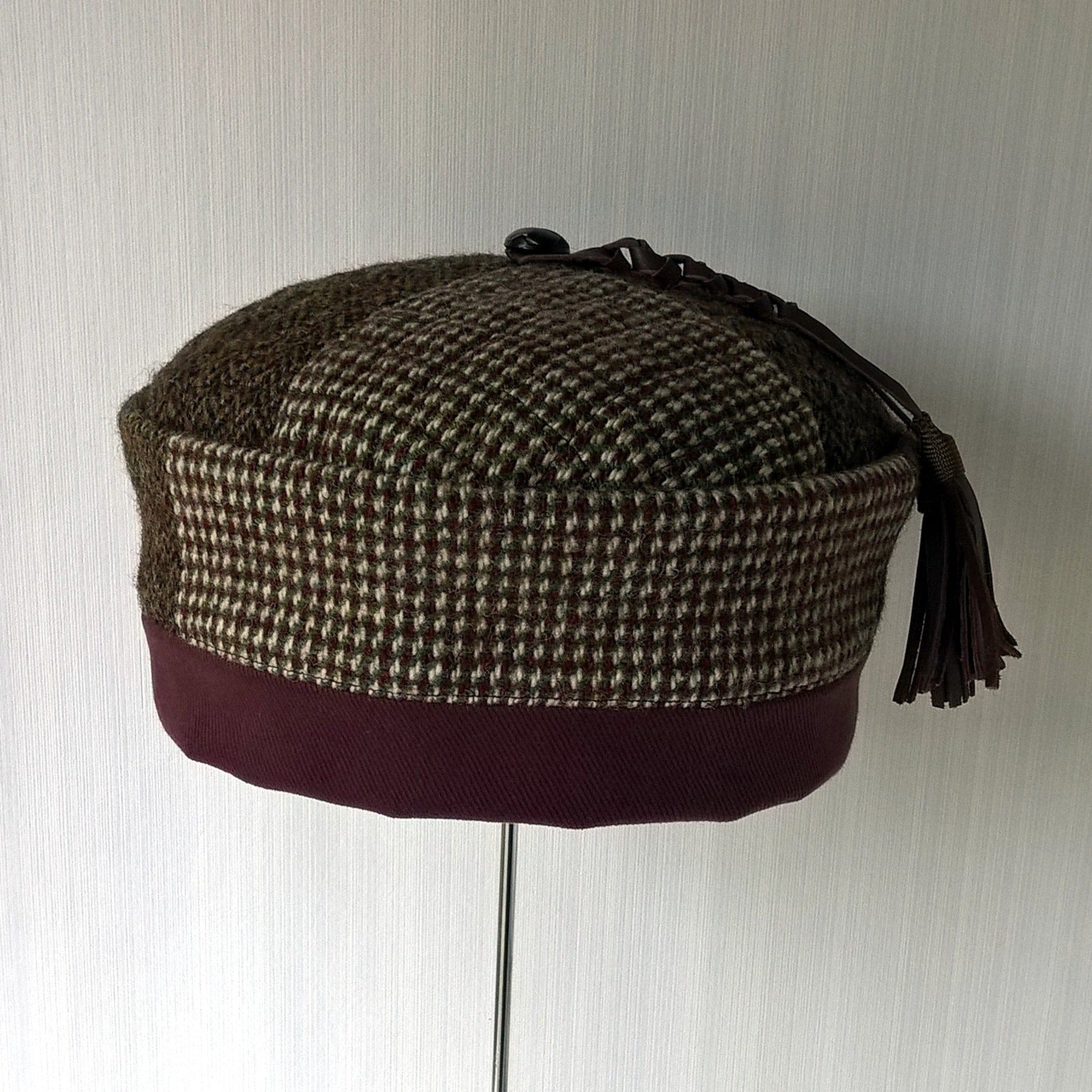 Front of Harris Tweed smoking cap with leather tassel