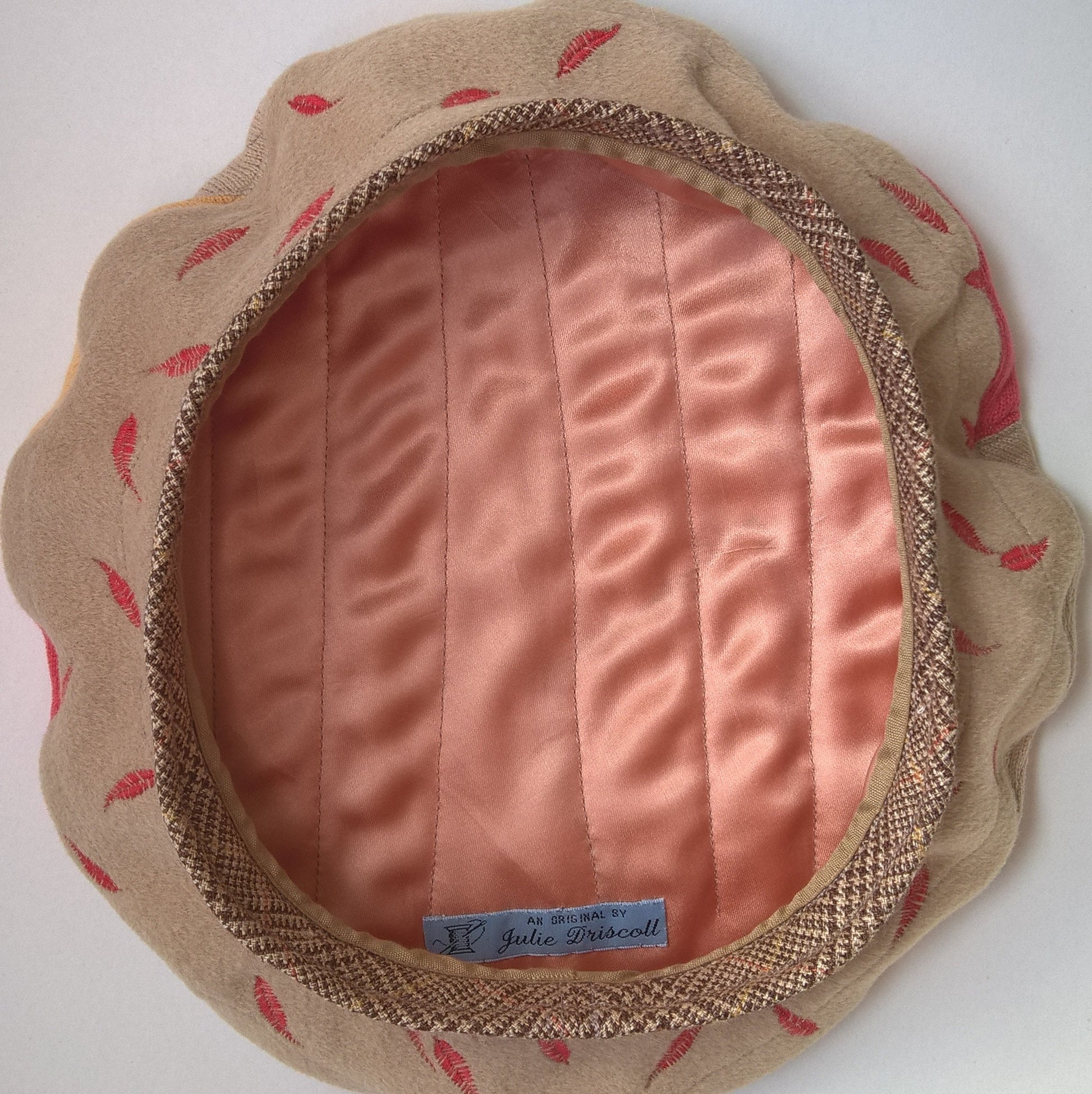 The beret is lined with peach satin which is quilted to the cashmere outer