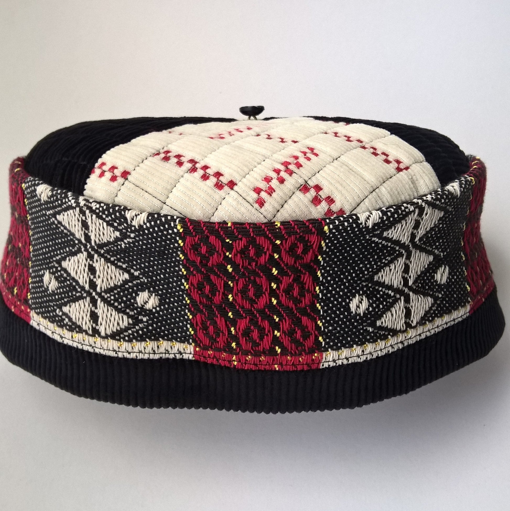 Handmade brimless smoking cap in an Aztec design of black, cream, red and gold