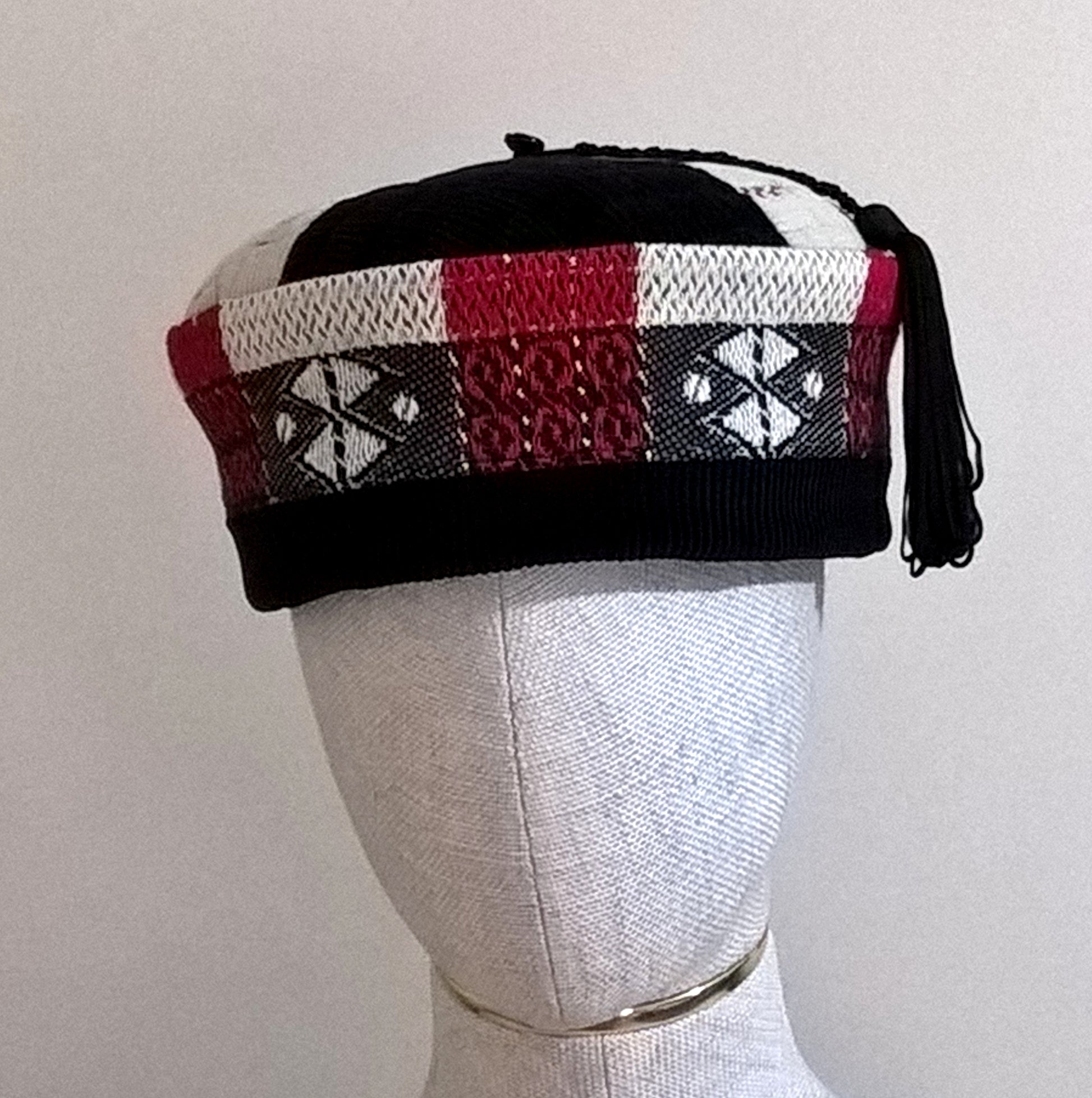 Vibrant patterned handmade smoking cap in black, red and cream with macrame tassel