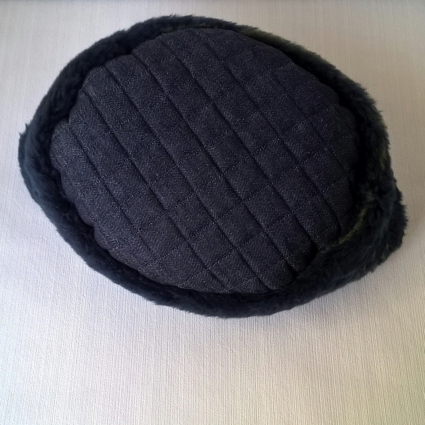 This blue wool fur hat has a denim quilted tip