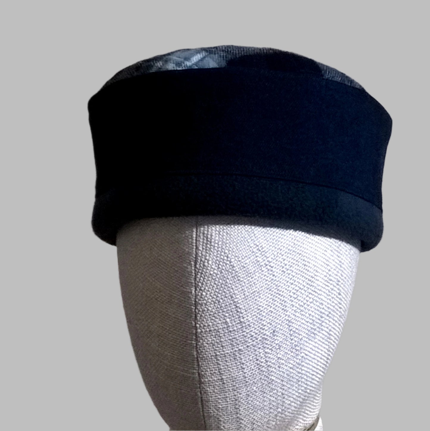 Brimless blue fleece and denim pillbox style hat with check pattern tip