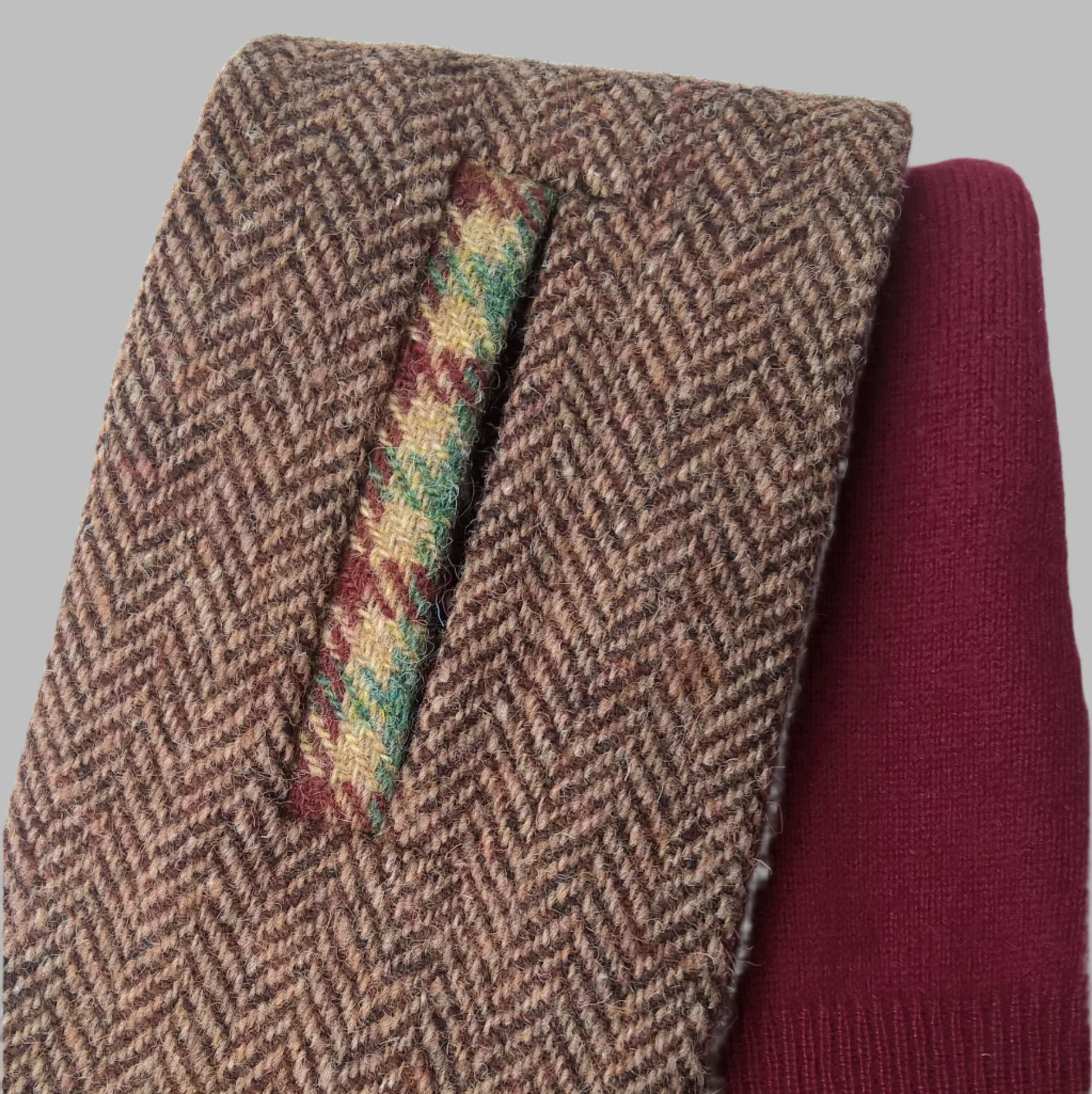 Harris Tweed keyhole scarf in reddish brown herringbone with burgundy and green check  trim and lined in burgundy pure cashmere knit