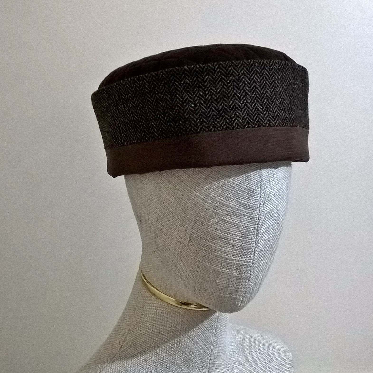 Wool pillbox cap in brown herringbone with quilted tip