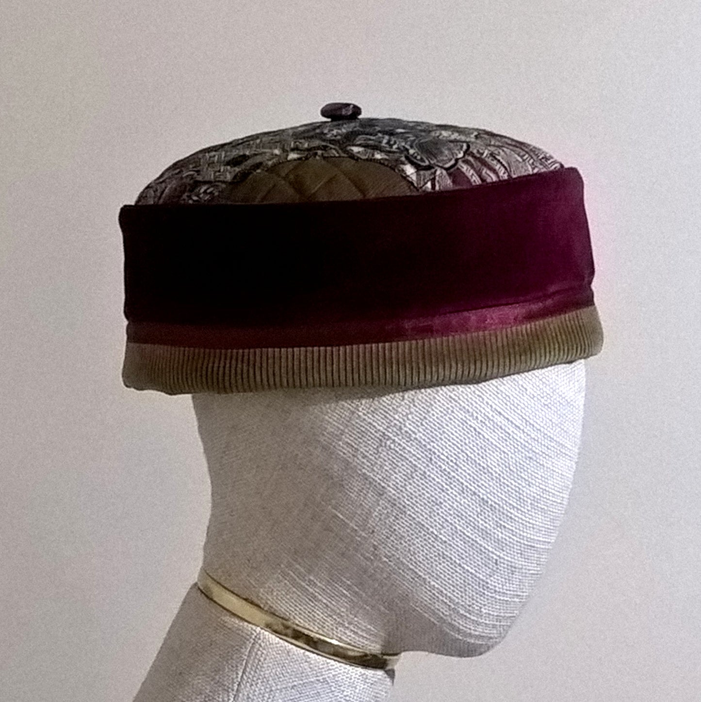 Burgundy velvet and paisley pillbox cap with centre button and removable tassel