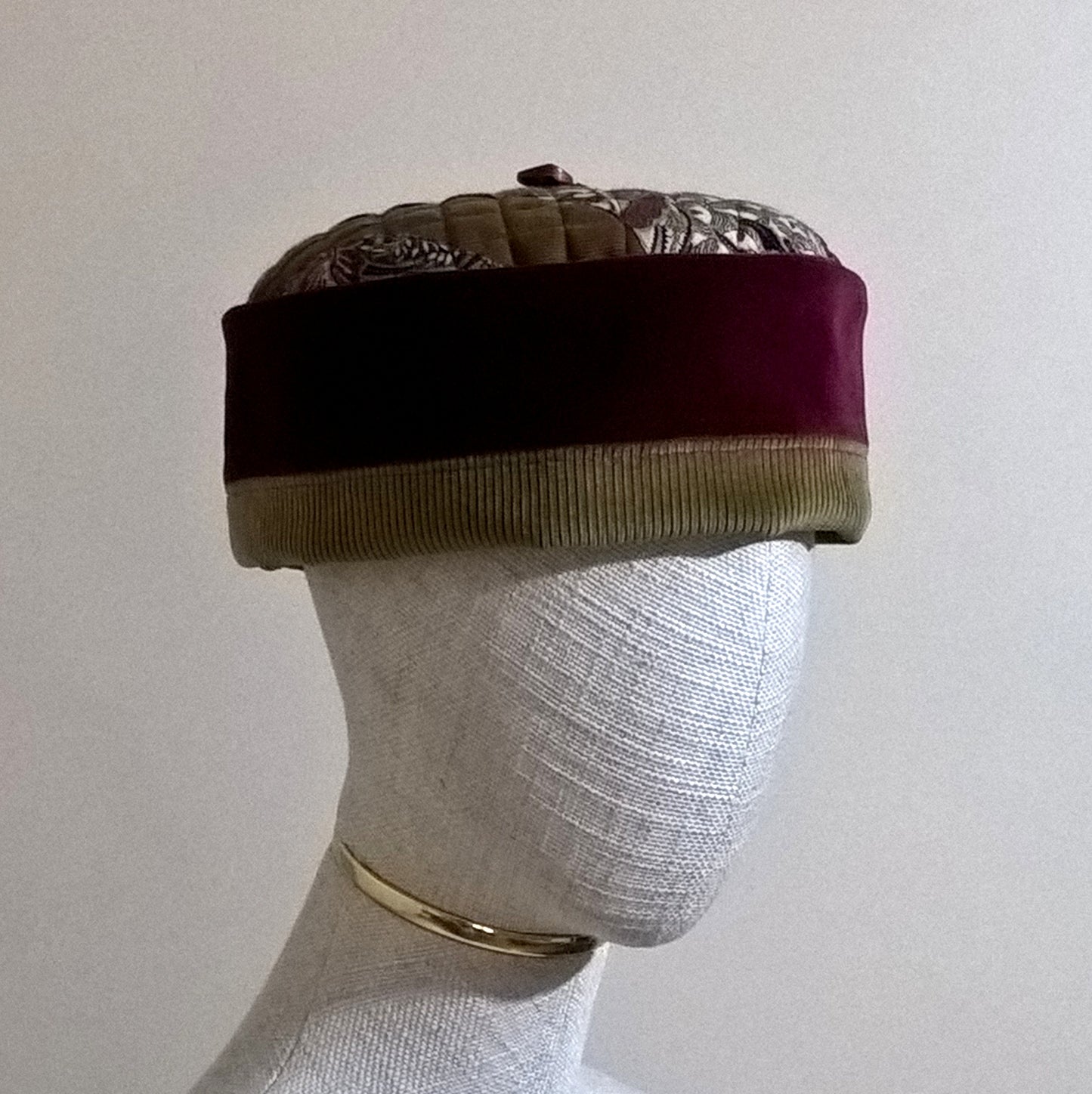 The pillbox shaped hat can be worn without the tassel