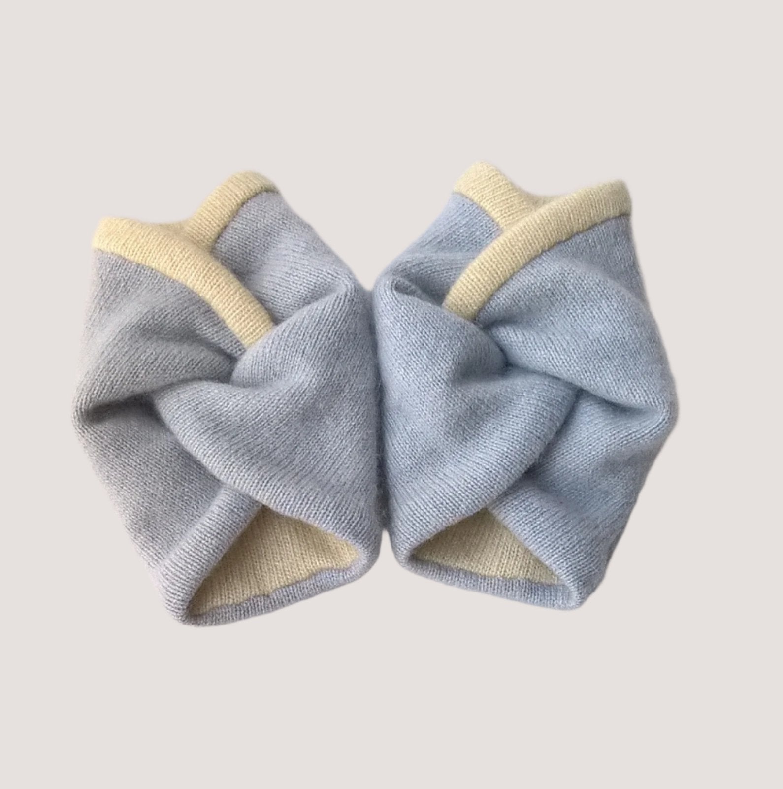 Cashmere wrist warmers handmade from up-cycled sweaters in pale blue and cream.