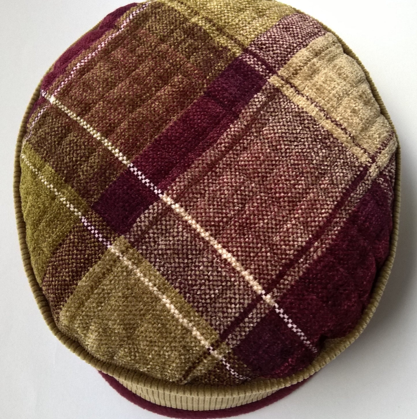 Tip of hat in olive green and burgundy check patterned chenille 