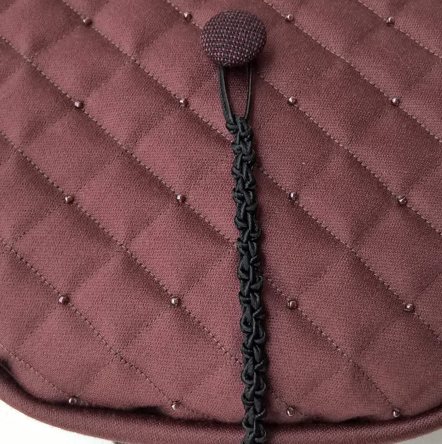 Tip of smoking cap is quilted, beaded and a complimenting button added for the removable handcrafted macrame tassel