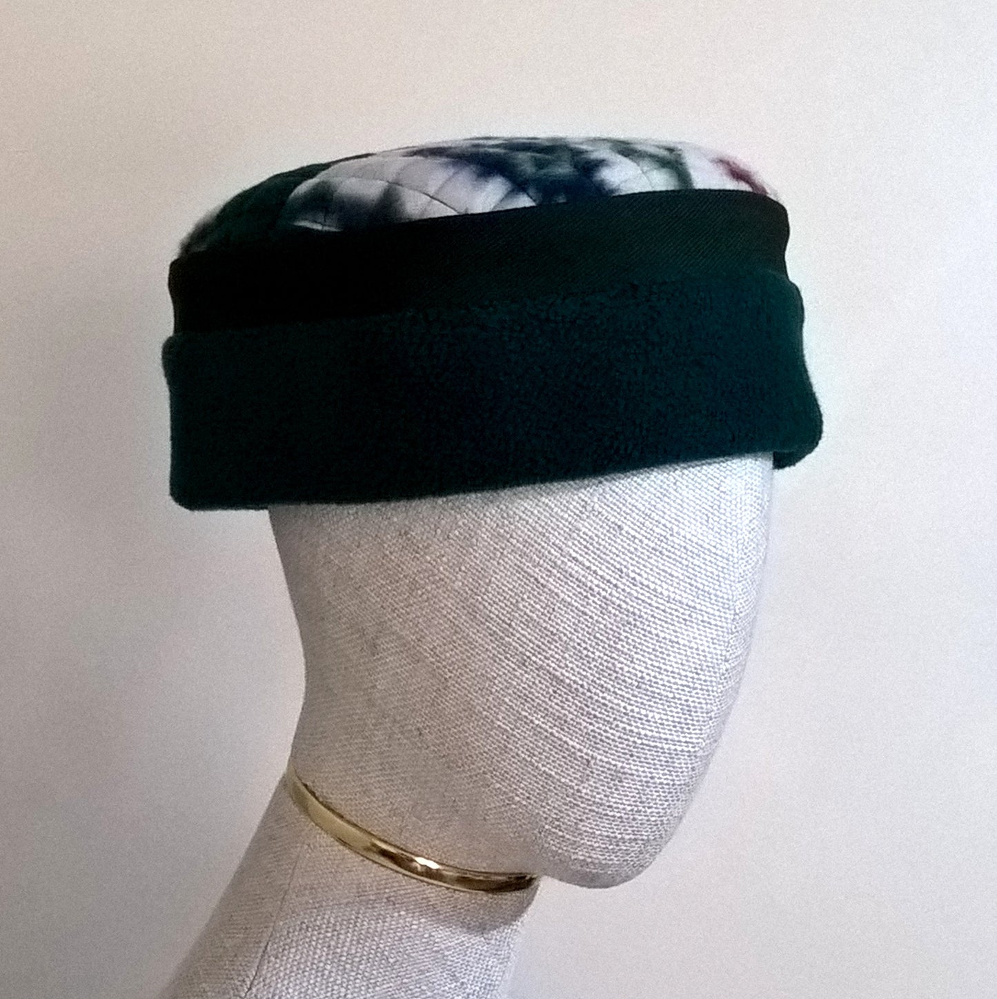 Forest green fleece brimless cap with Aztec patterned tip