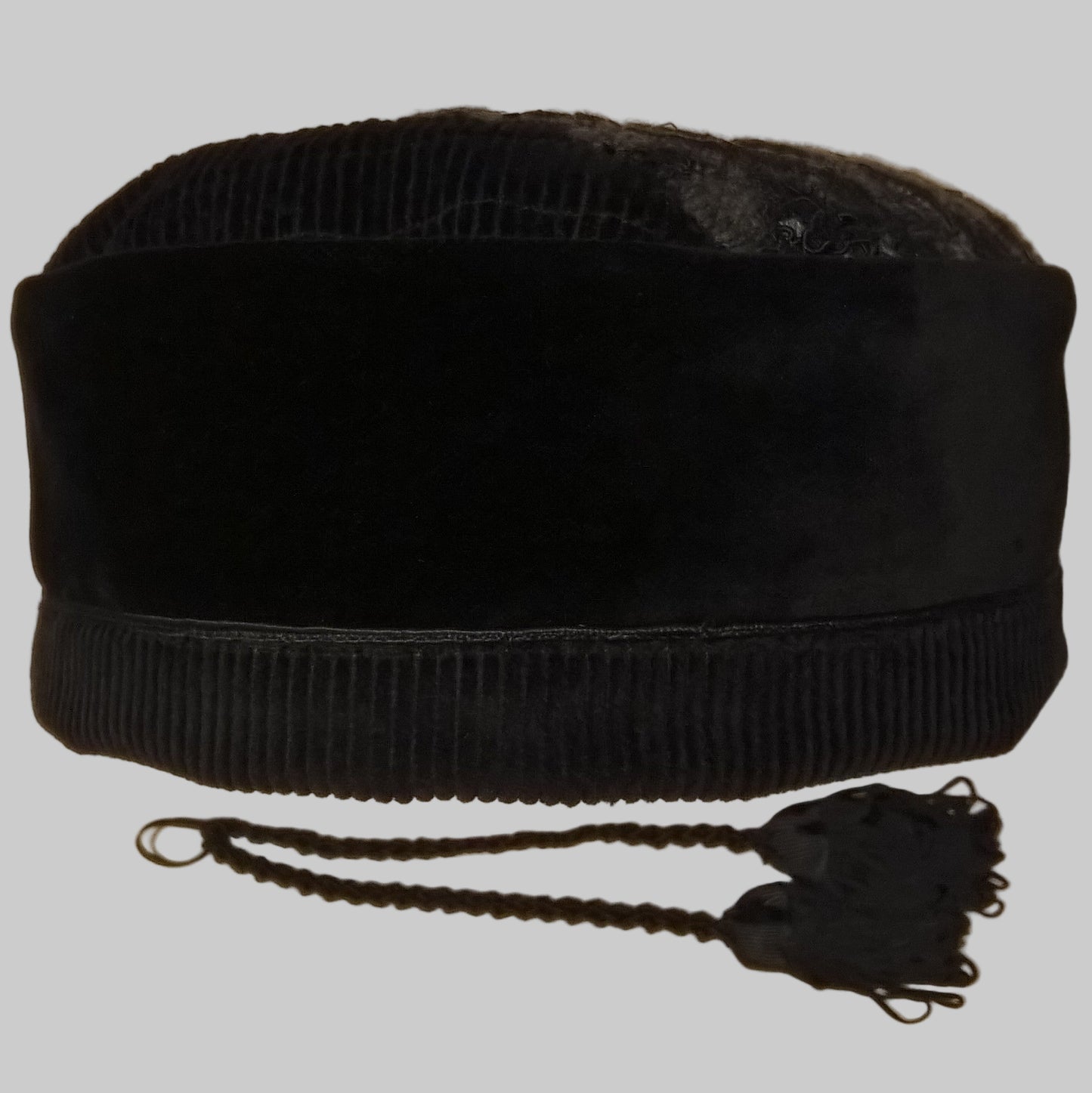 Front of black velvet smoking cap with removable tassels