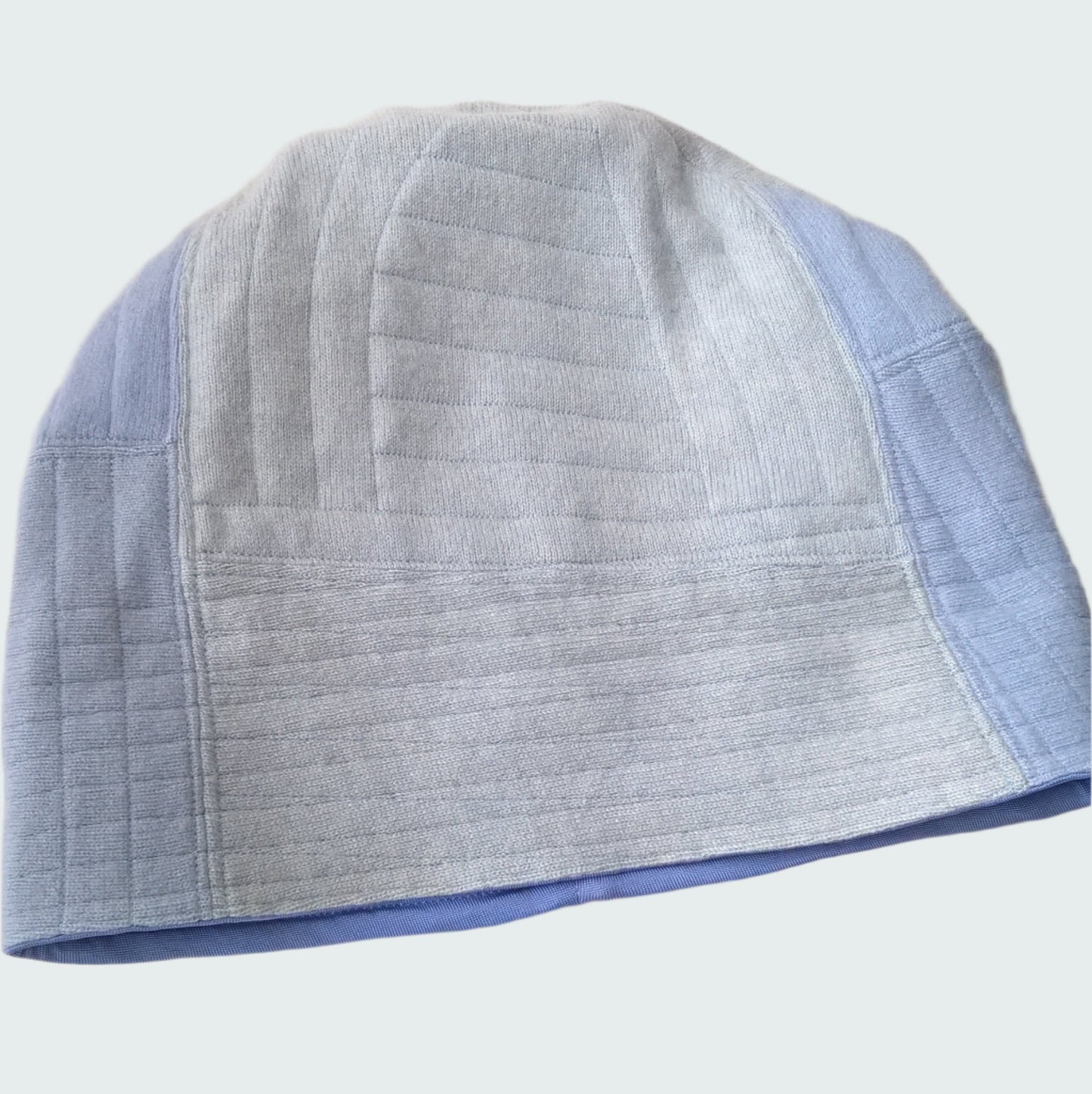 Front of cashmere beanie with cuff rolled down to show patchwork design