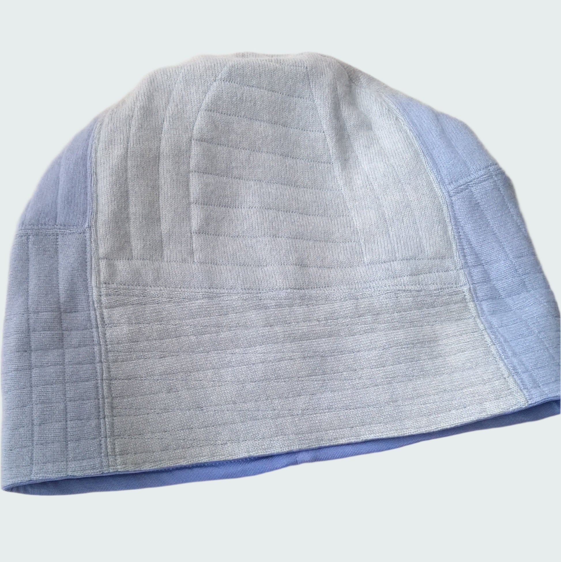 Front of cashmere beanie with cuff rolled down to show patchwork design