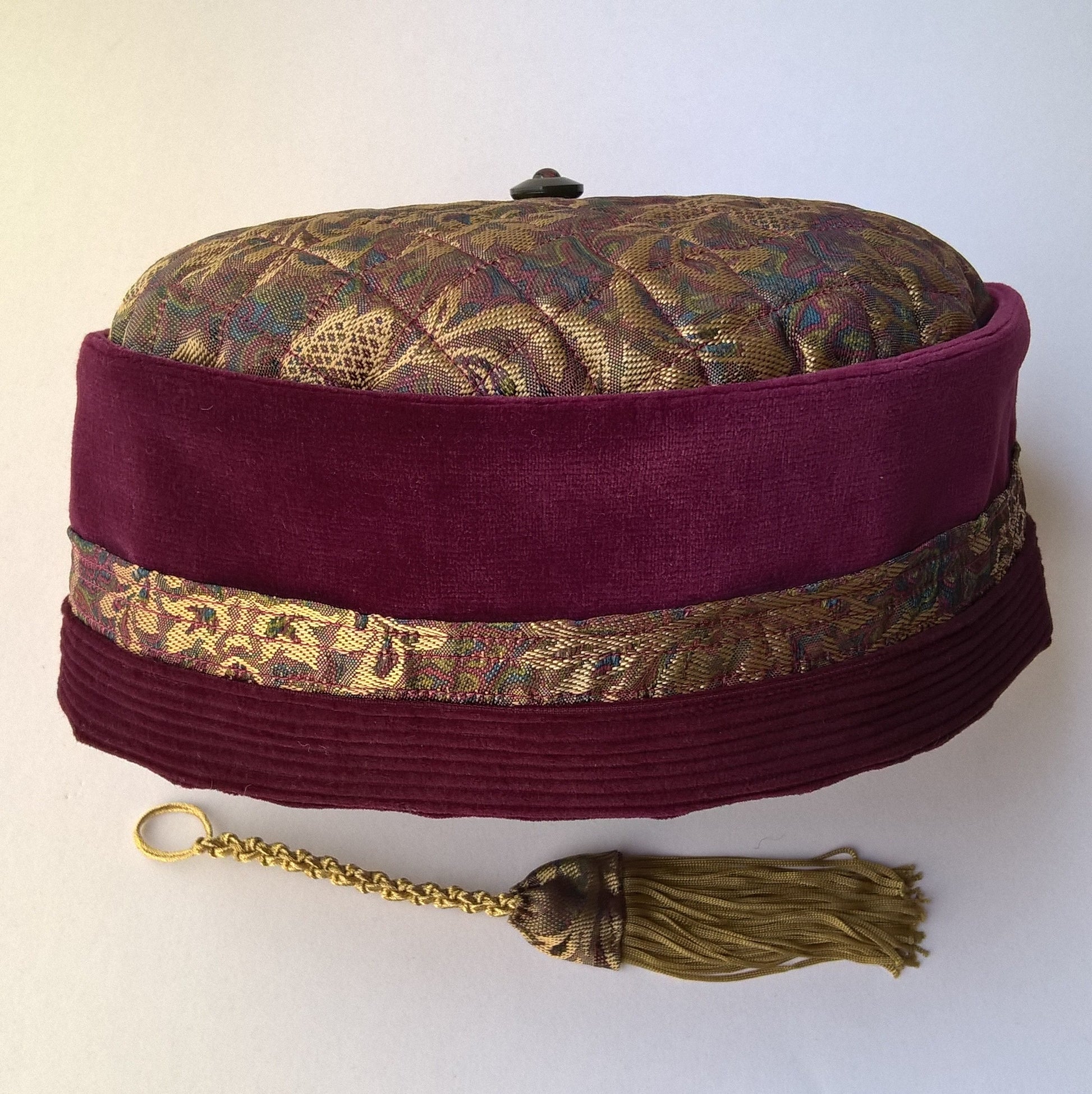 The velvet and brocade smoking cap has a removable tassel