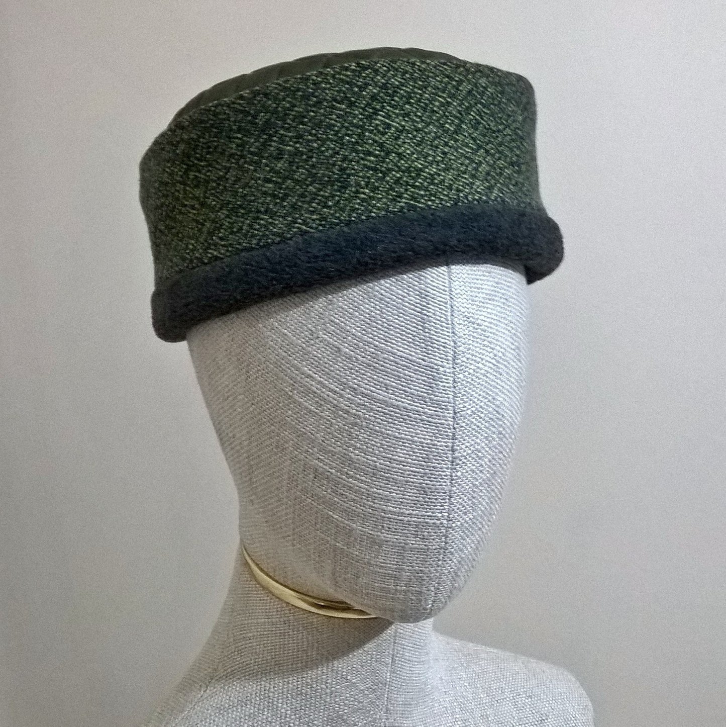 Mottled green wool brimless hat with grey marl fleece lining