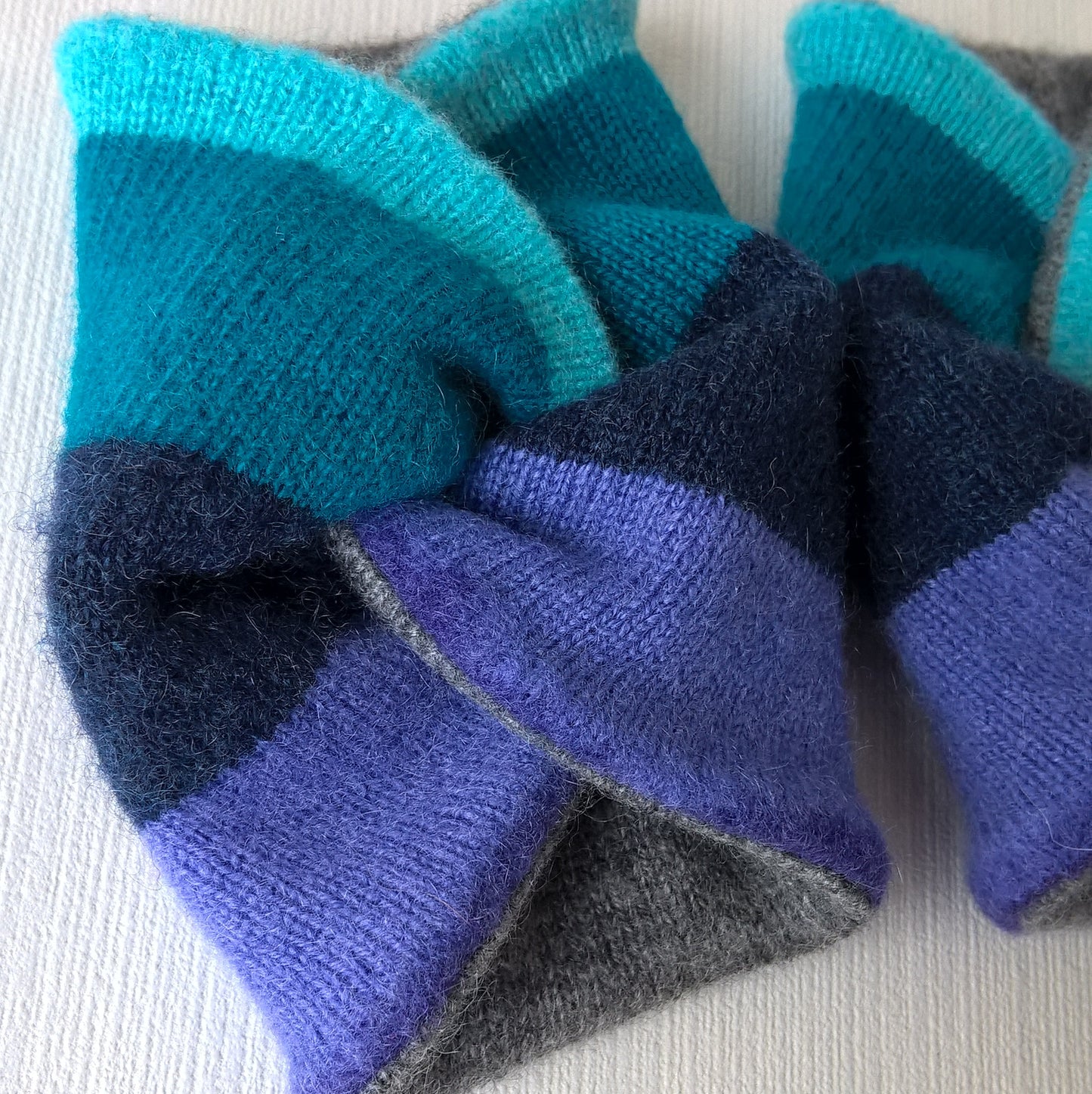 Cashmere wrist warmers in green and purple stripe lined with grey