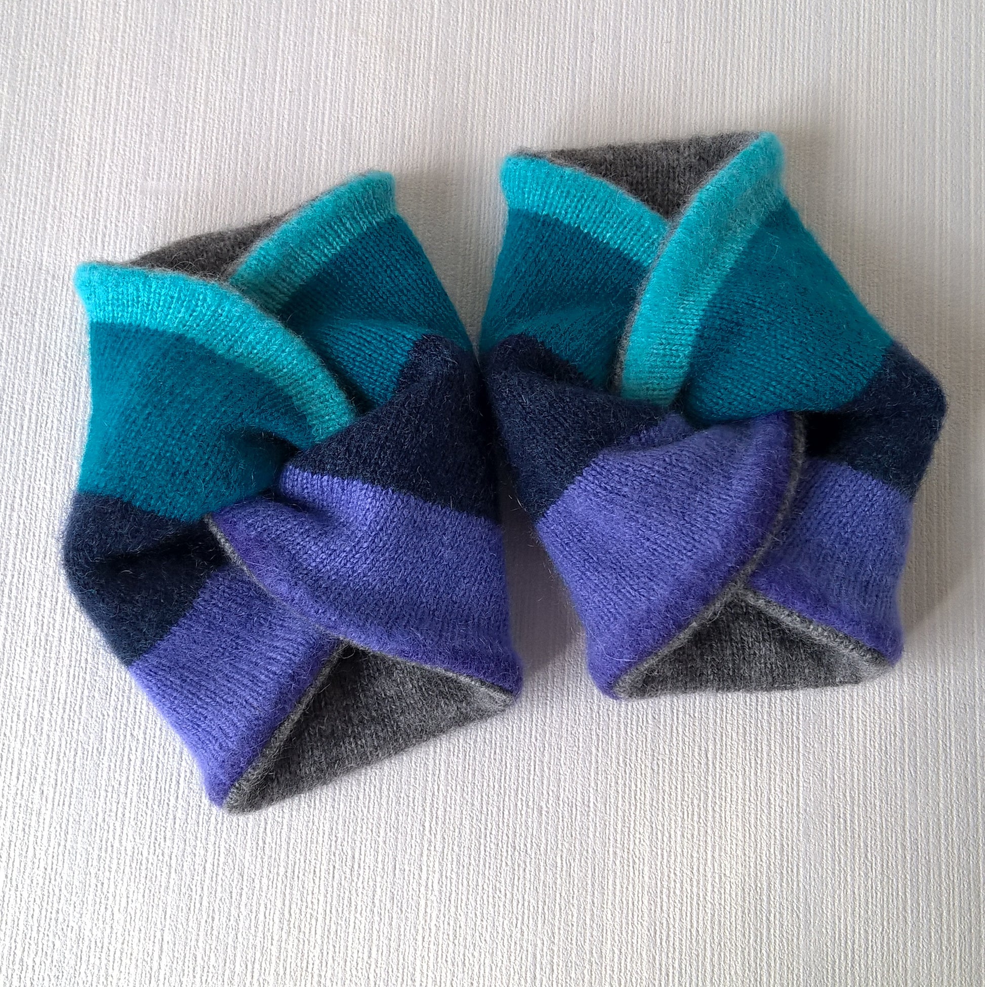 Cashmere wrist warmers in a twisted knot design