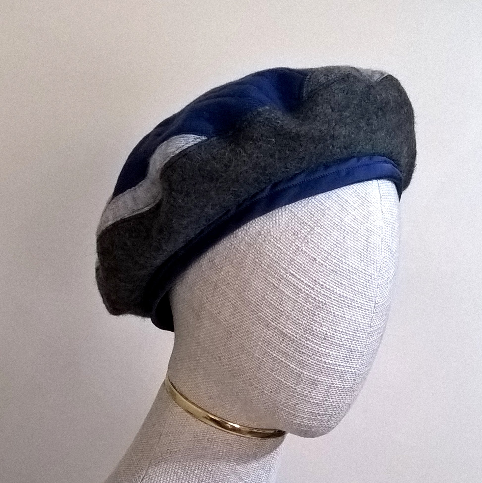 Blue and grey patchwork beret handmade with up-cycled cashmere sweaters and pure wool felt and lined with silk