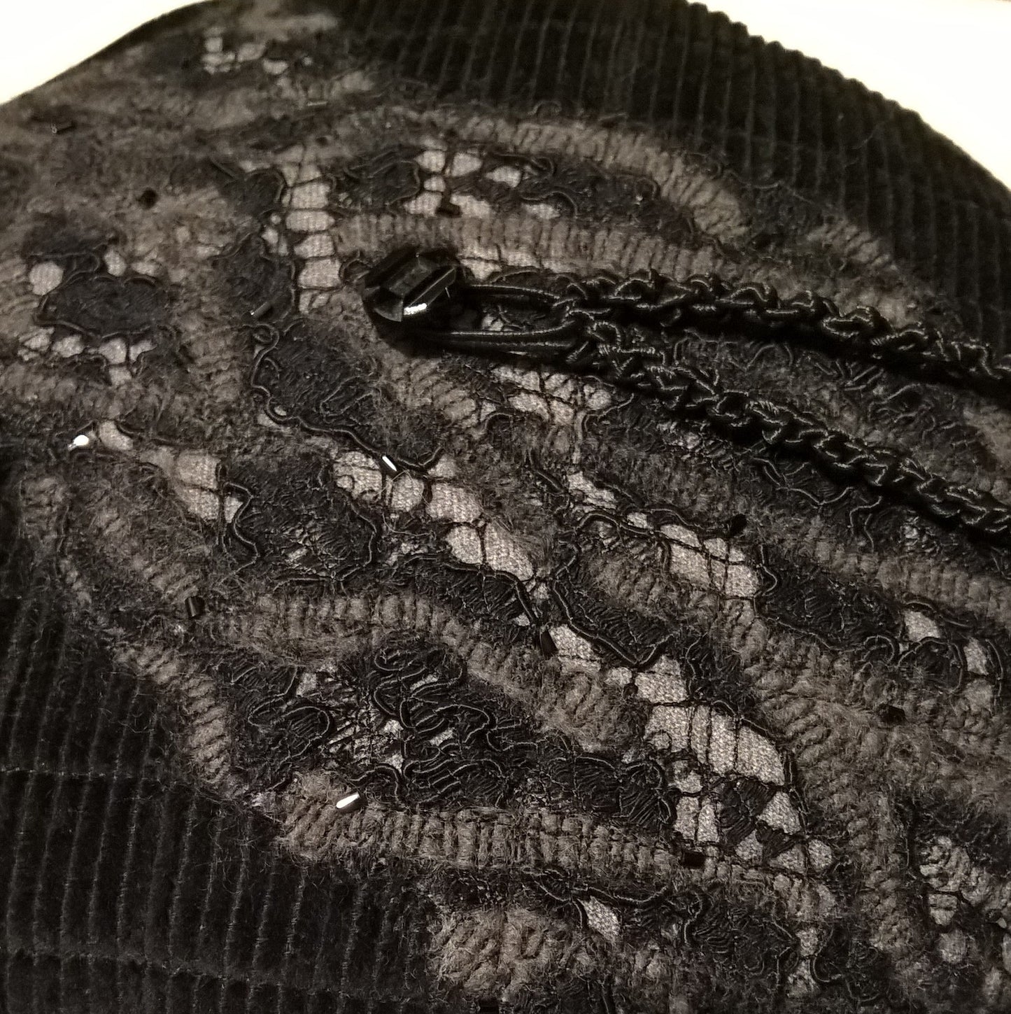 The textured felted tip of black lace and grey  wool is hand beaded with jet black bugle beads