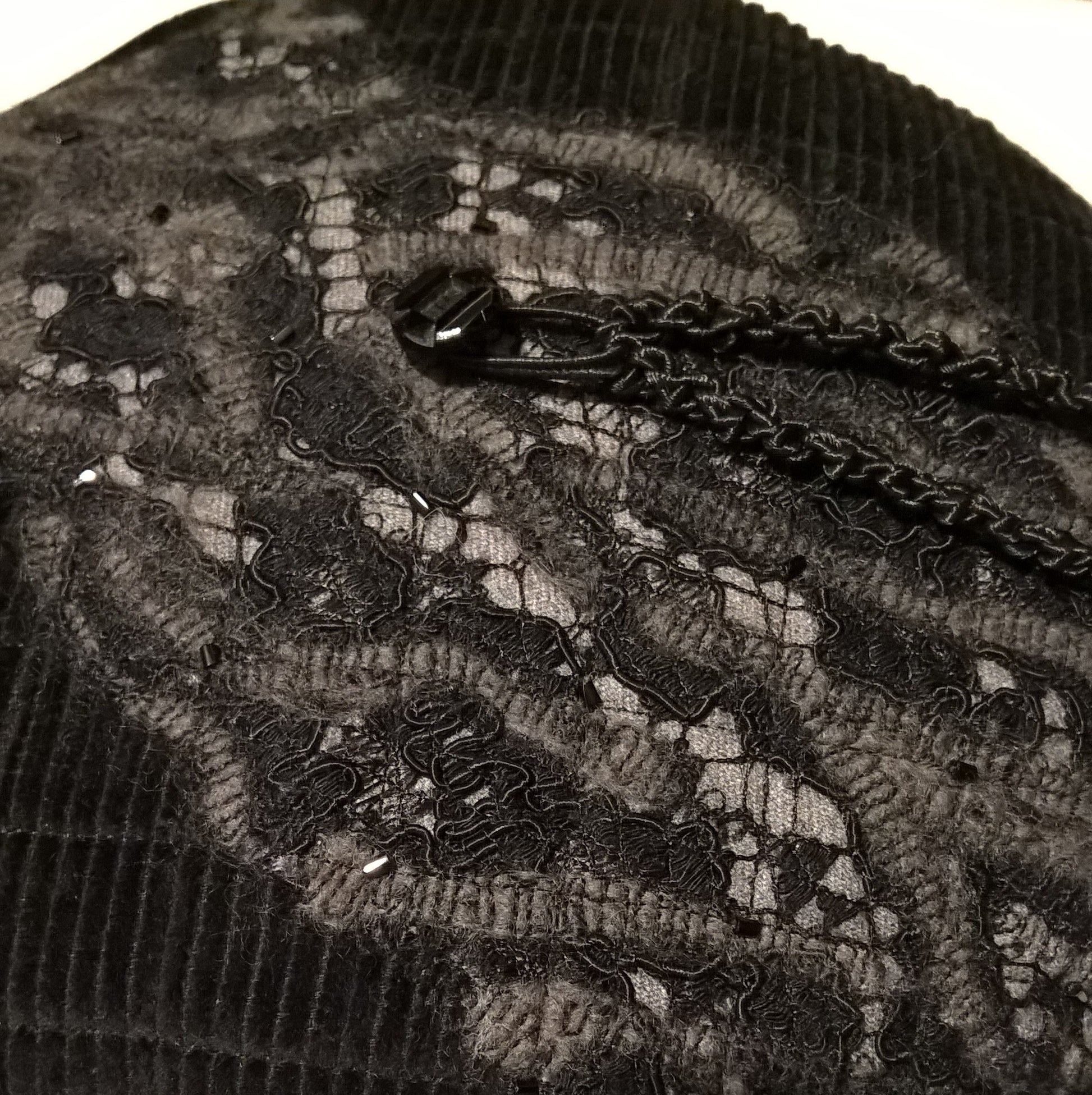 The textured felted tip of black lace and grey  wool is hand beaded with jet black bugle beads