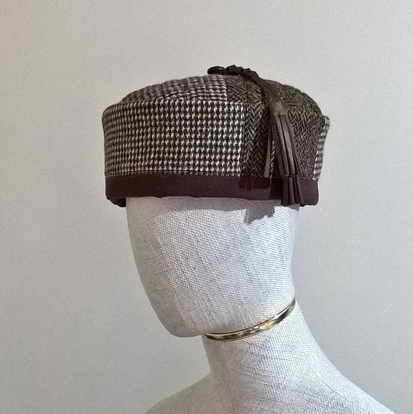 Harris tweed smoking cap in a mismatched patchwork design with leather tassel