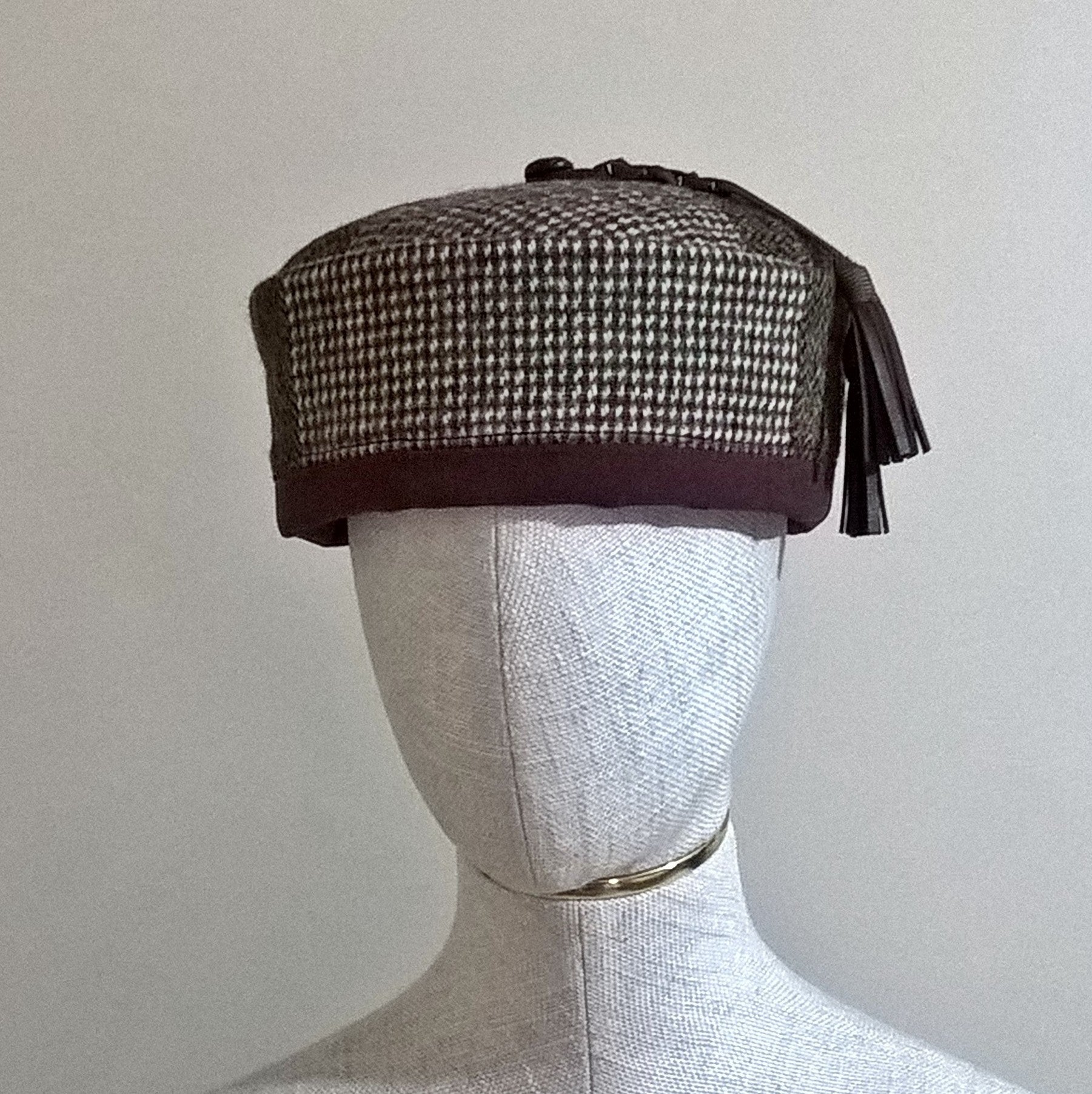 Front view of Harris tweed brimless hat with leather tassel