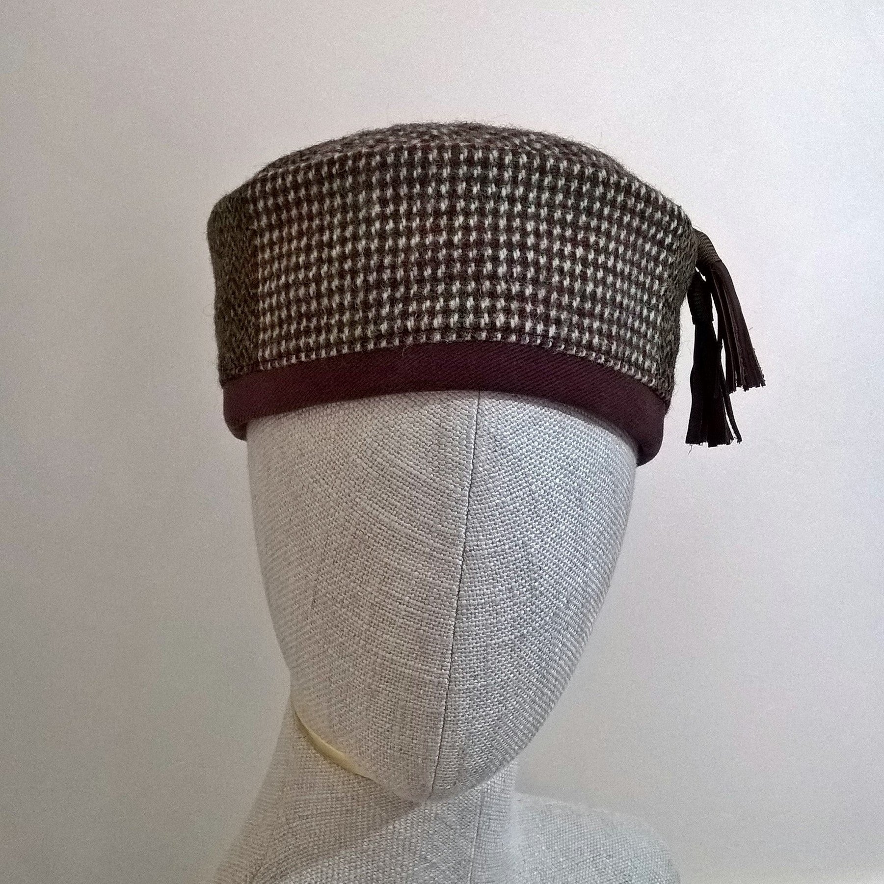 Harris Tweed wool smoking cap, in browns, cream and mauve shades, with macrame leather tassel