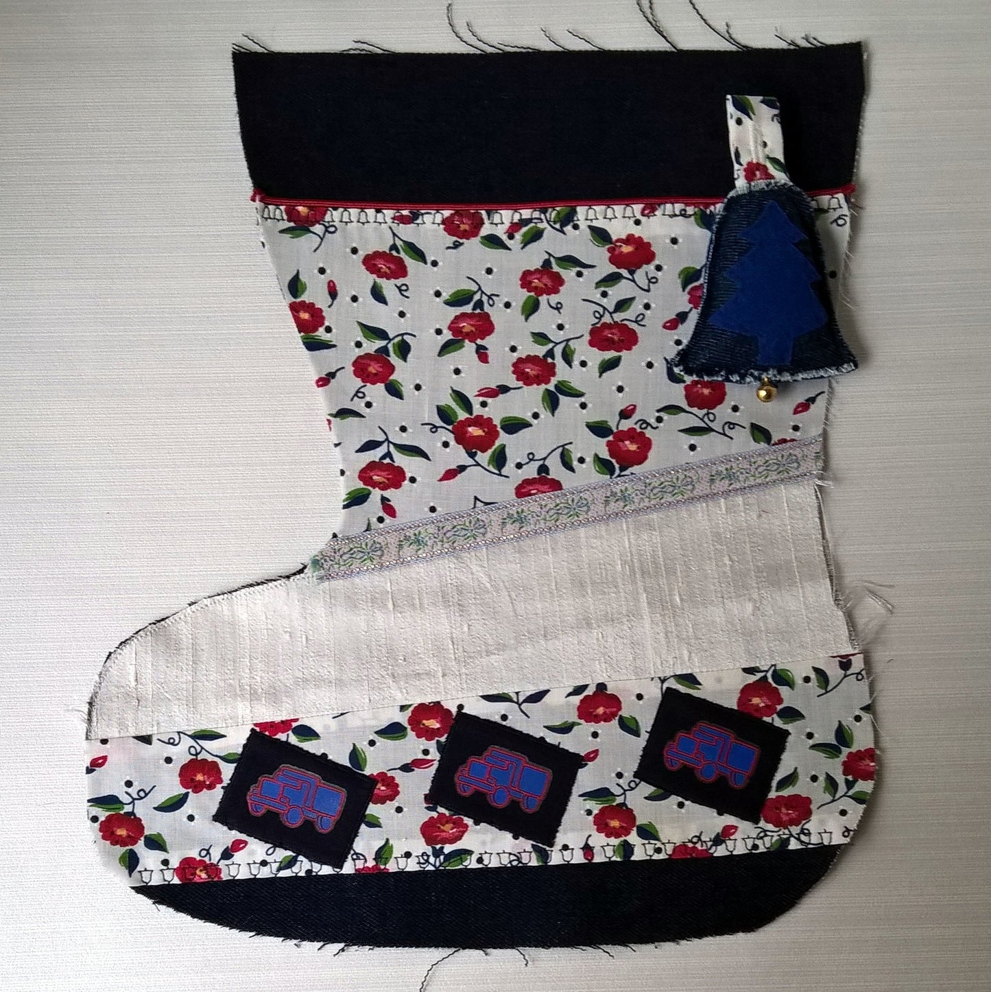 Indigo denim patchwork Christmas stocking  with truck motifs and a jungle bell ready to be hand embroidered