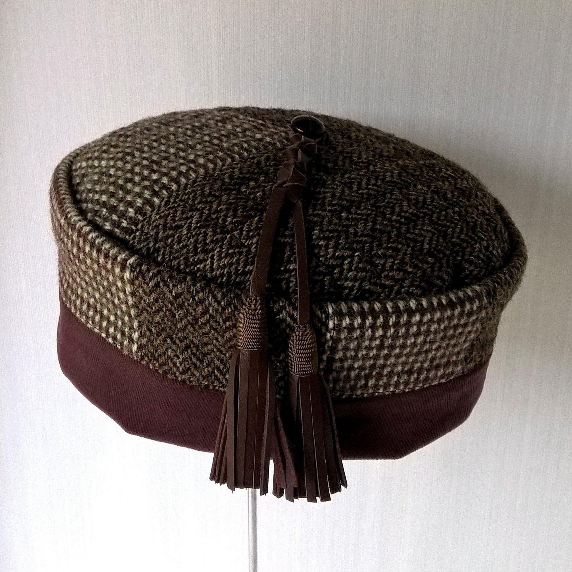 Smoking cap crafted from vintage Harris Tweed jackets in patchwork design with leather tassel