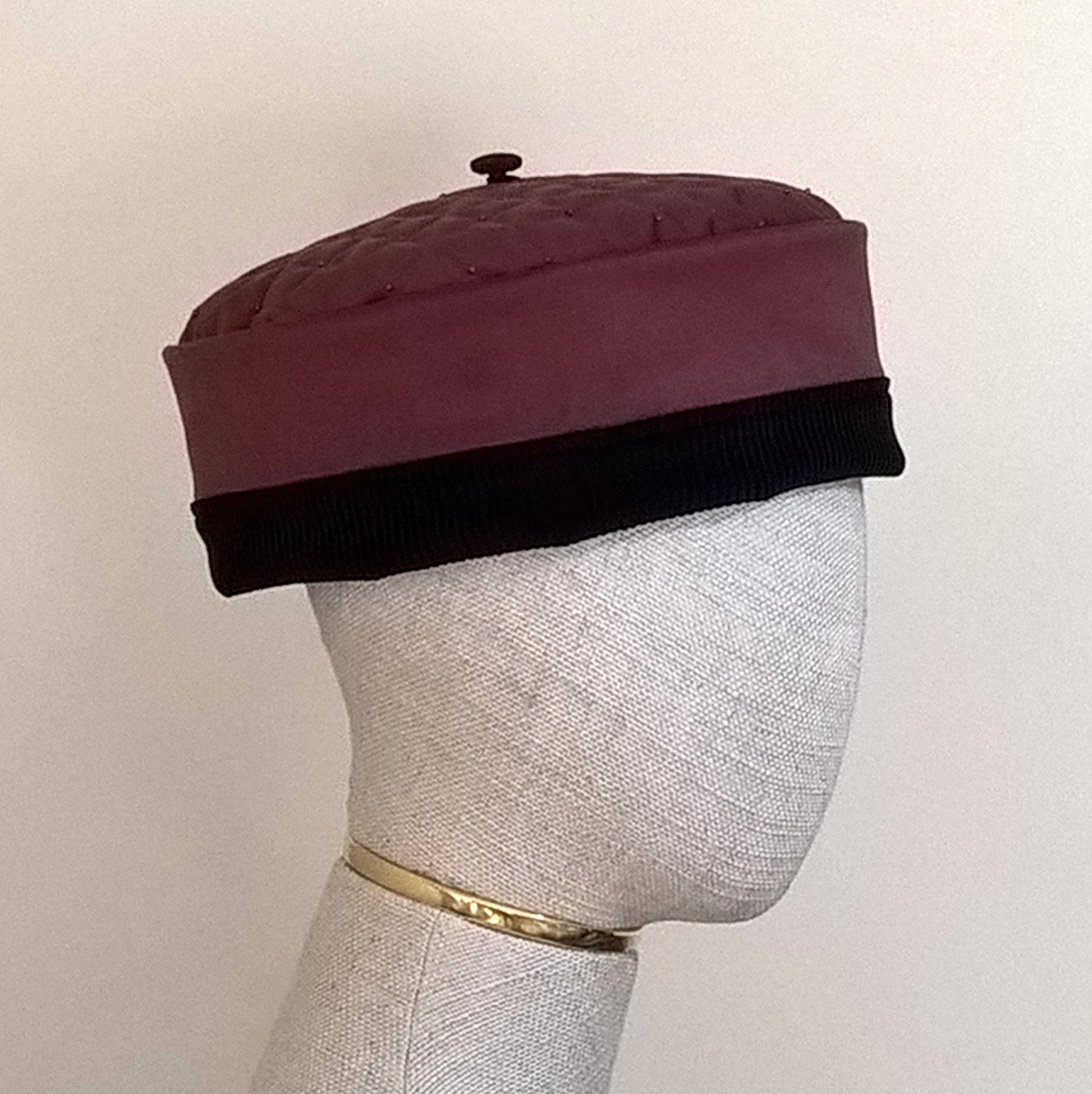 The pillbox shaped hat has a removable tassel