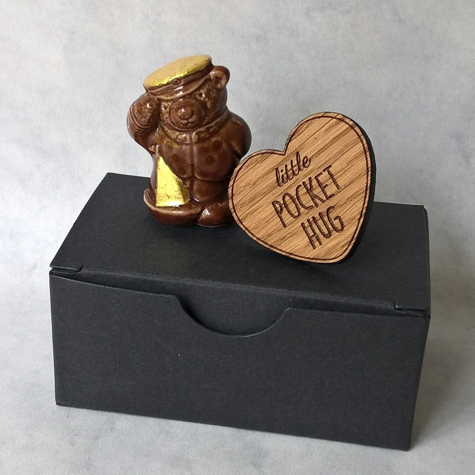 miniature ceramic bear embellished with pure gold leaf and wooden heart pocket hug 