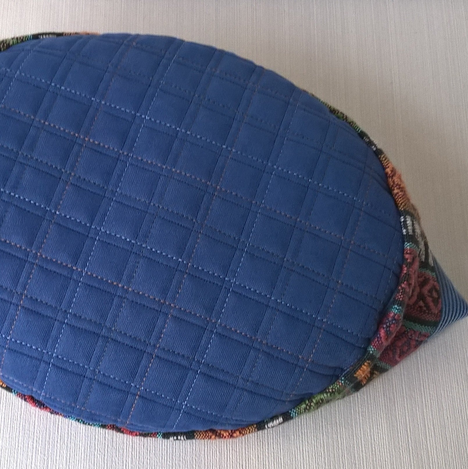 Quilted tip with contrast stitching on ethnic brimless cap