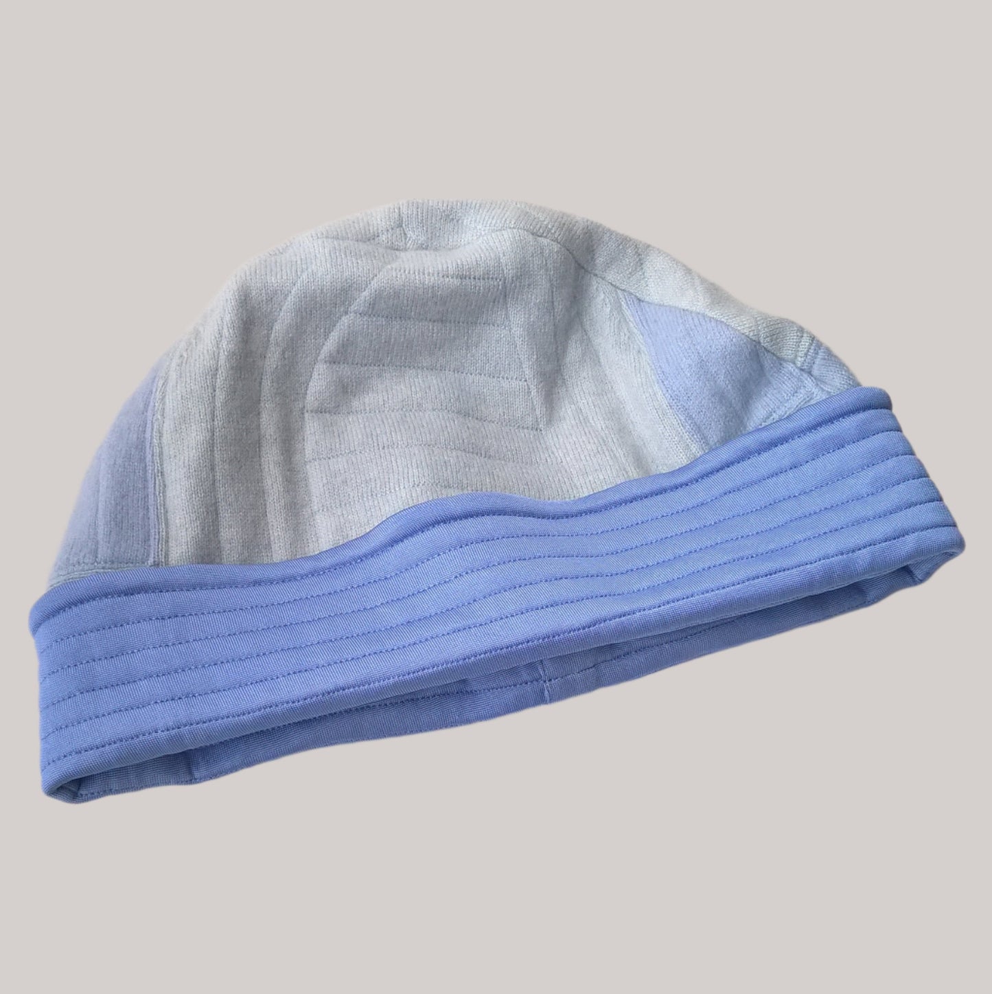 Blue patchwork cashmere beanie has a quilted silk cuff in bluebell