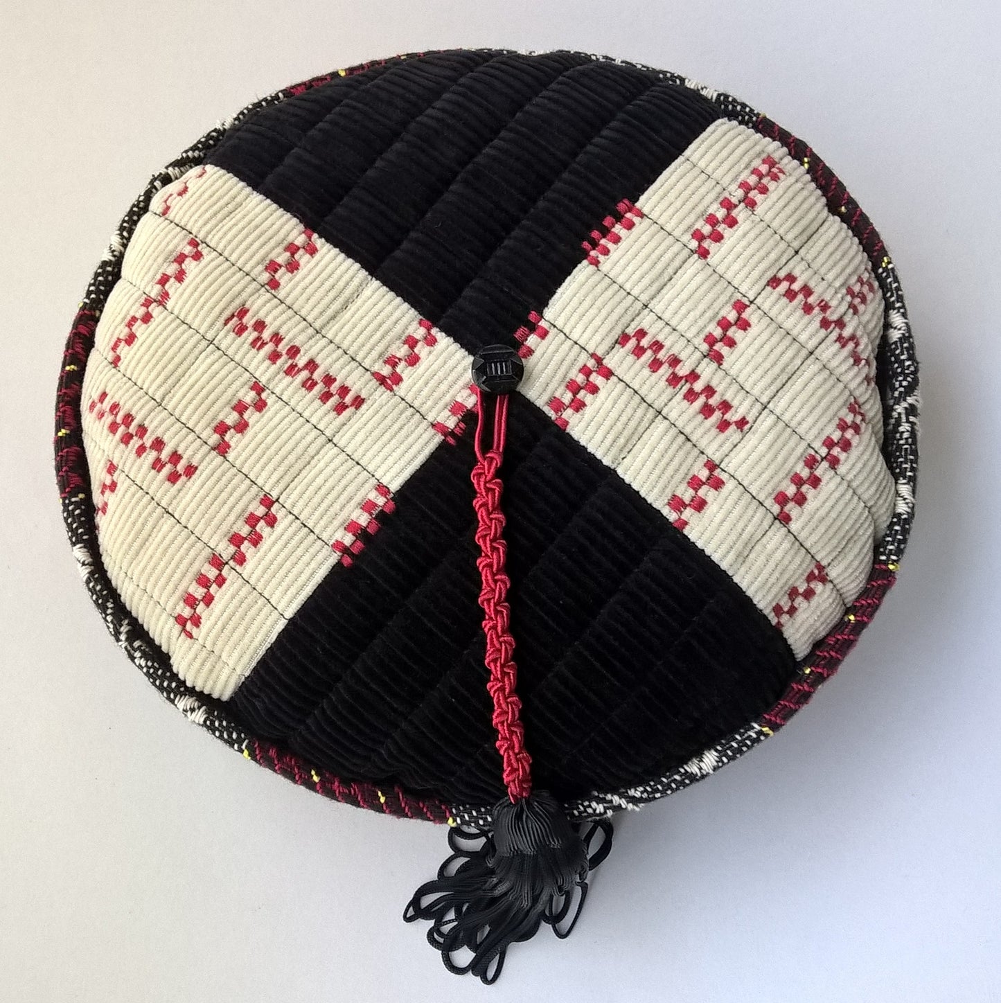 The hat has a patchwork segment tip embellished with machine  embroidery 