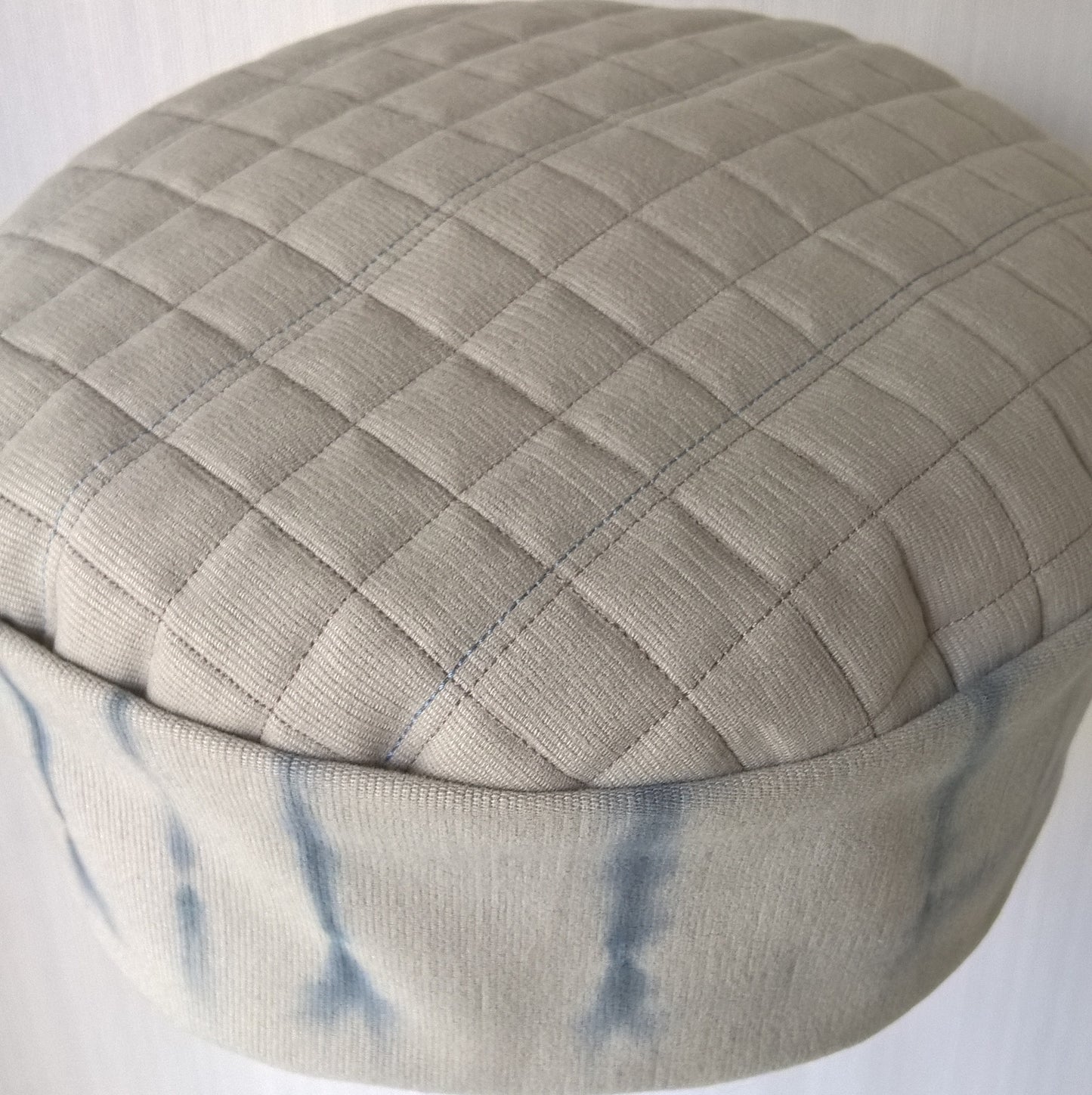 The tip is quilted in contrasting colours of taupe and blue