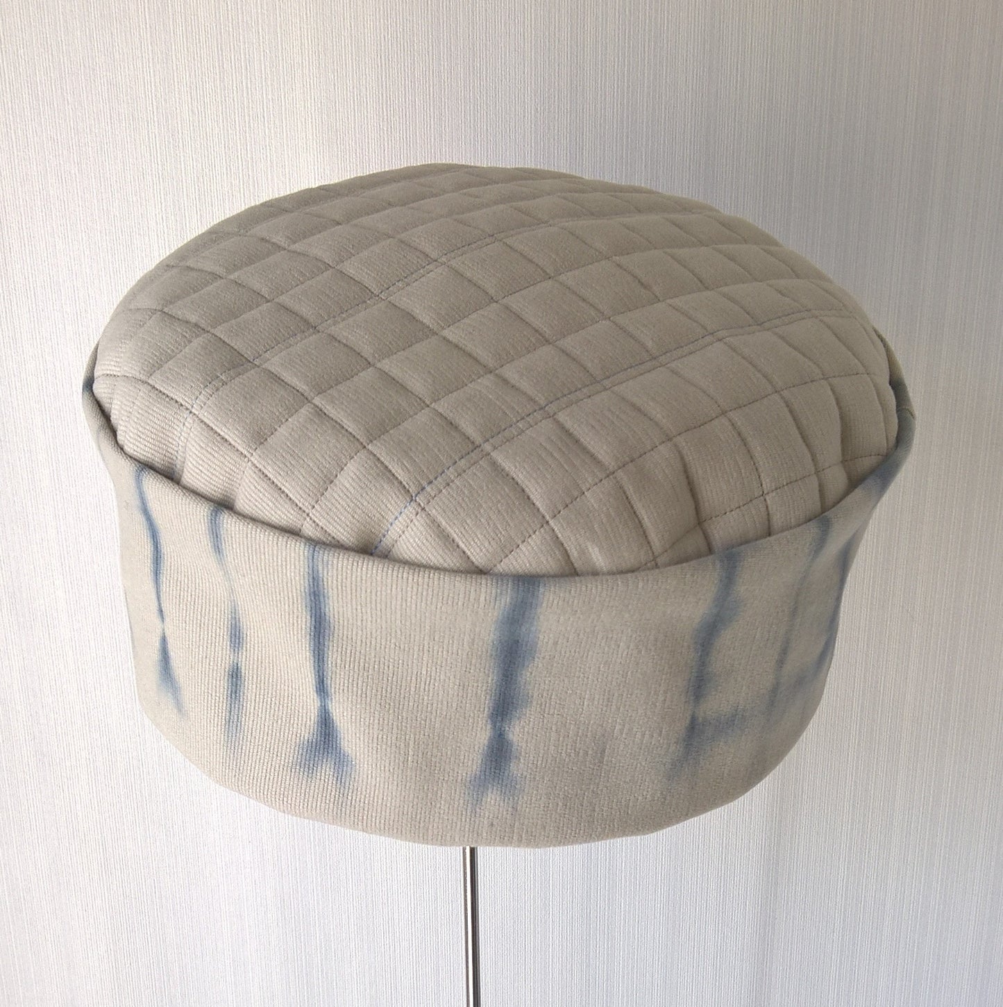 Pillbox shaped hat with quilted tip and tie dyed crown