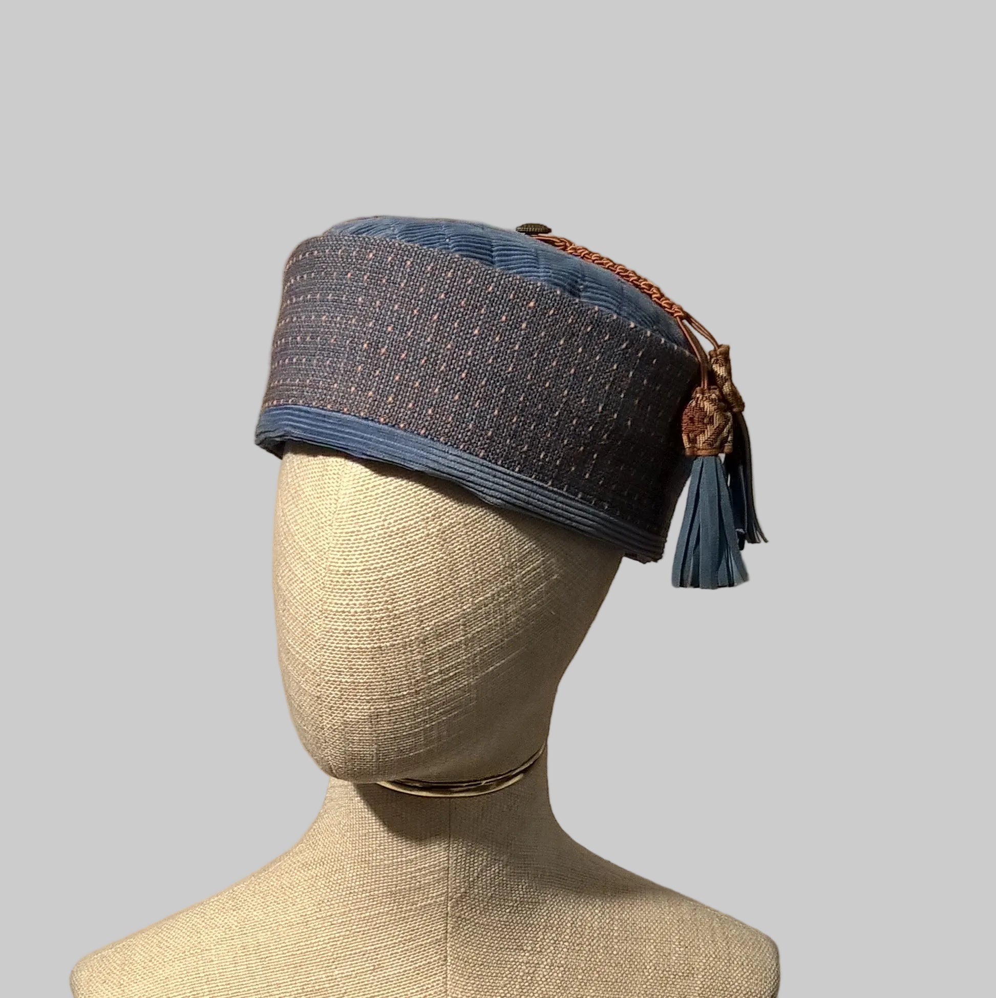 Blue quilted smoking cap with macrame and leather tassel
