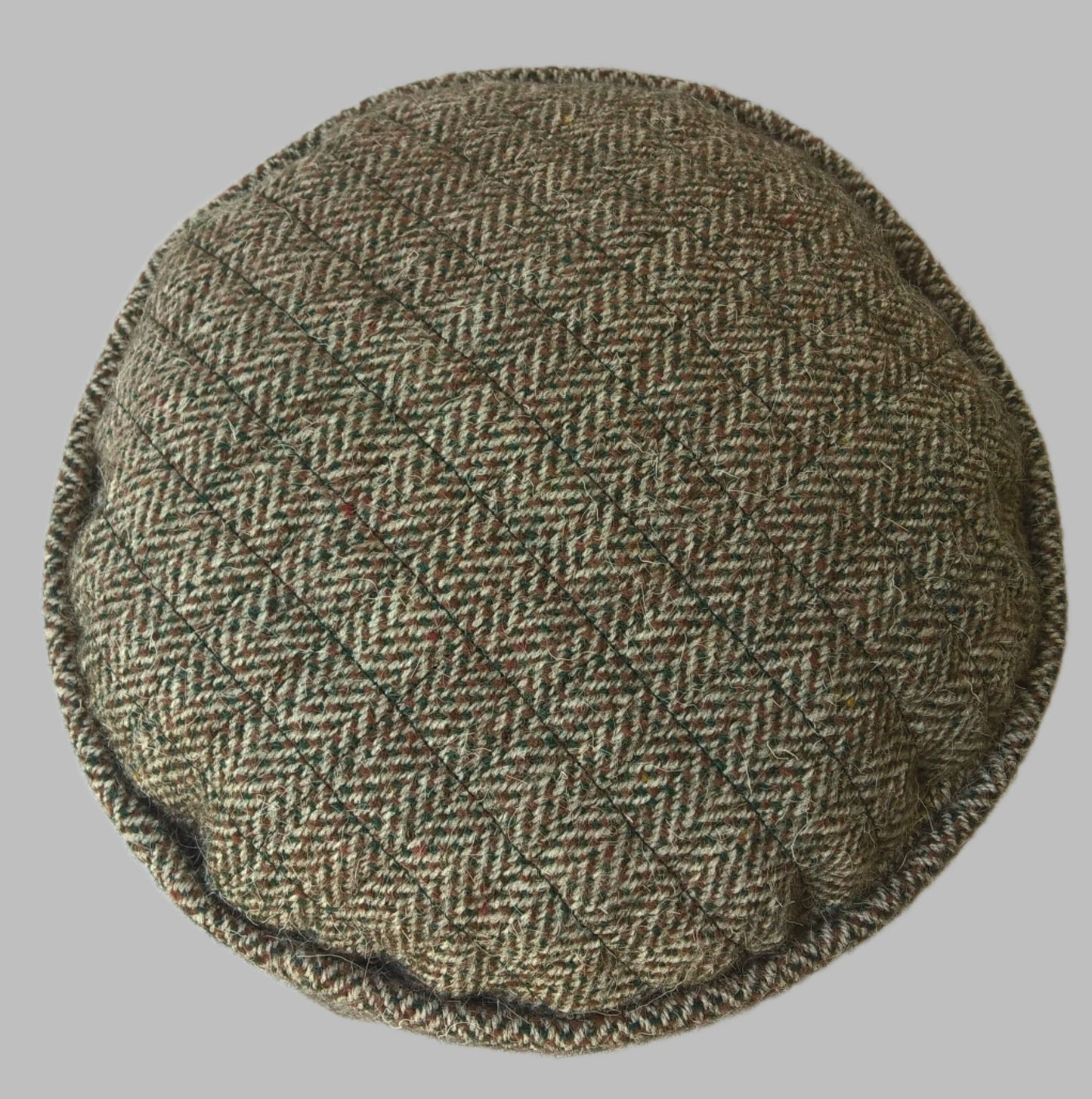 Quilted tip of handmade Harris Tweed brimless cap