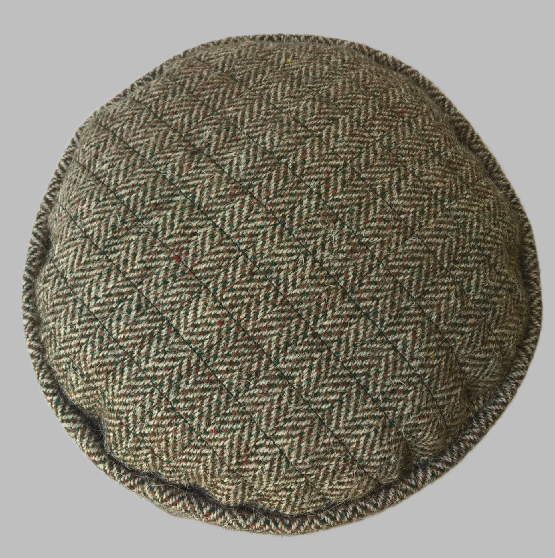 Quilted tip of handmade Harris Tweed brimless cap