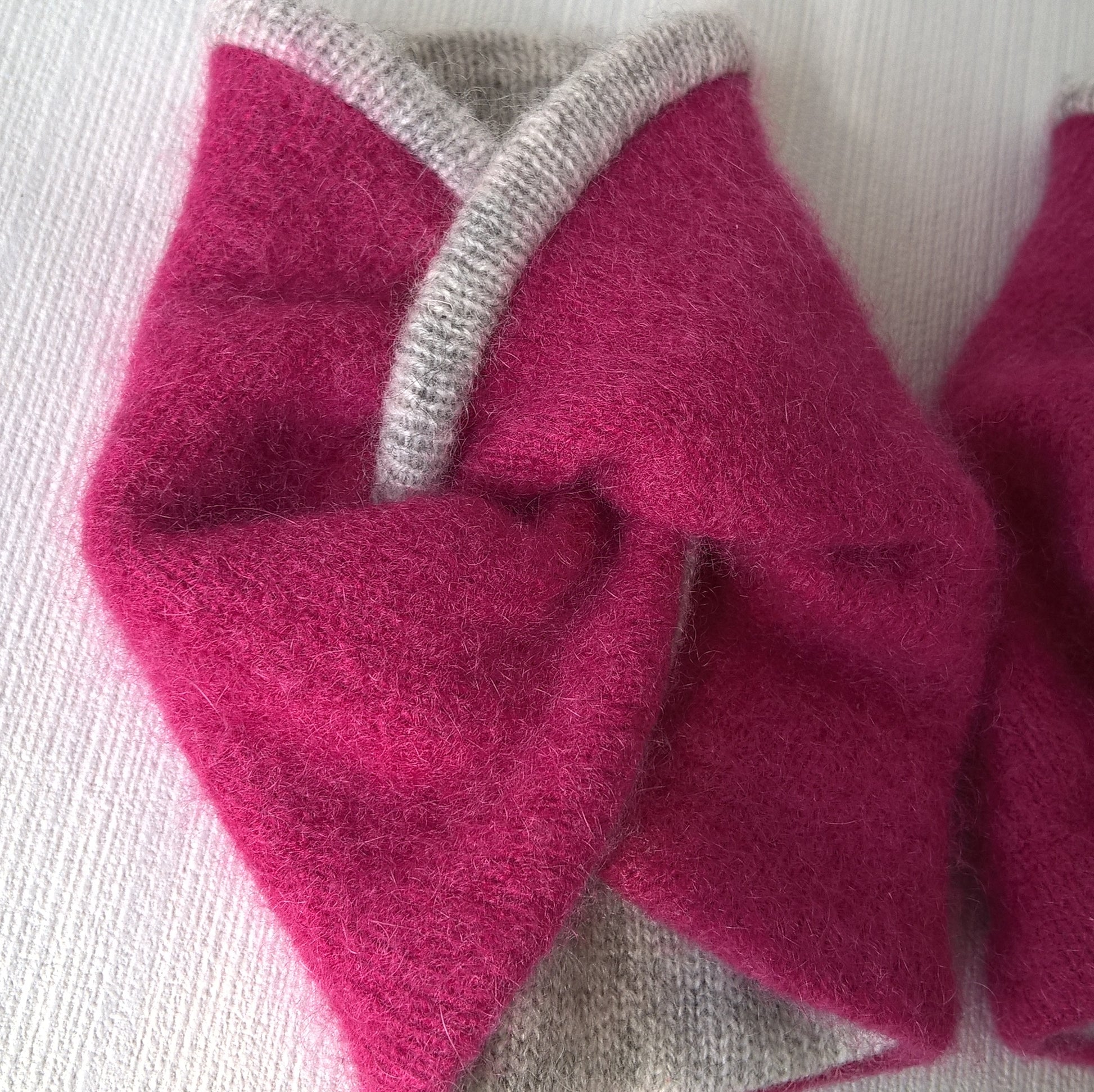 The upcycled raspberry pink cashmere is felted and lined with a fine knitted grey cashmere