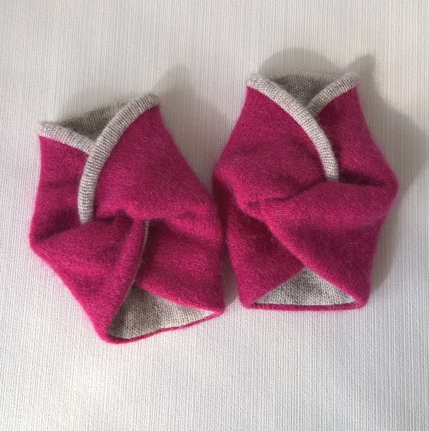 Felted raspberry pink cashmere edged and lined with grey cashmere