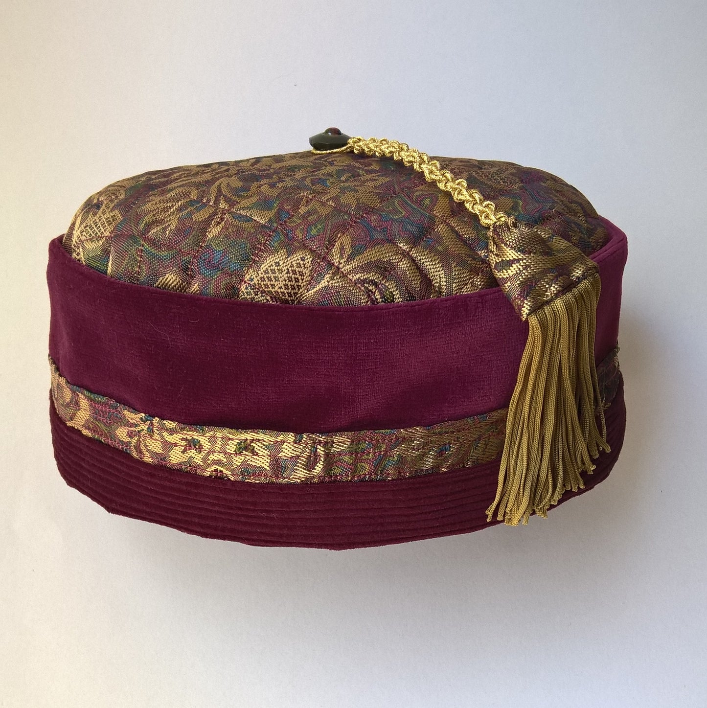 Victorian style gentleman's smoking cap in wine coloured velvet and gold brocade with go d macrame tassel