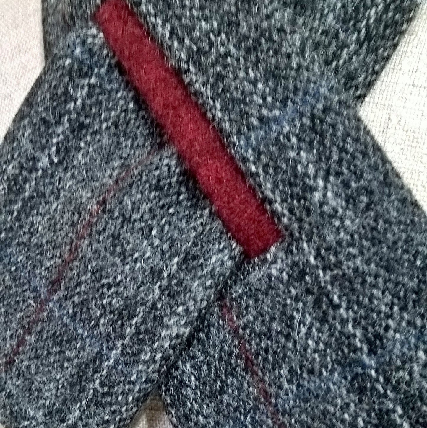 Close up to better show the grey  and red colours of the Harris Tweed scarf