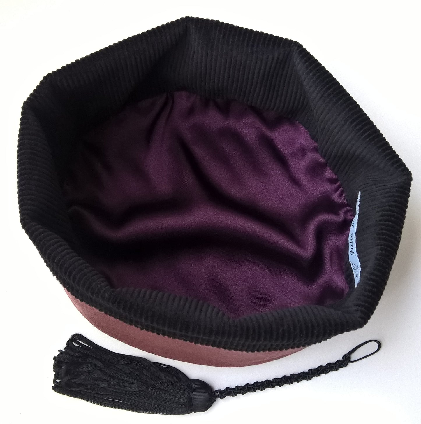 The smoking cap is lined with black cotton corduroy and aubergine satin