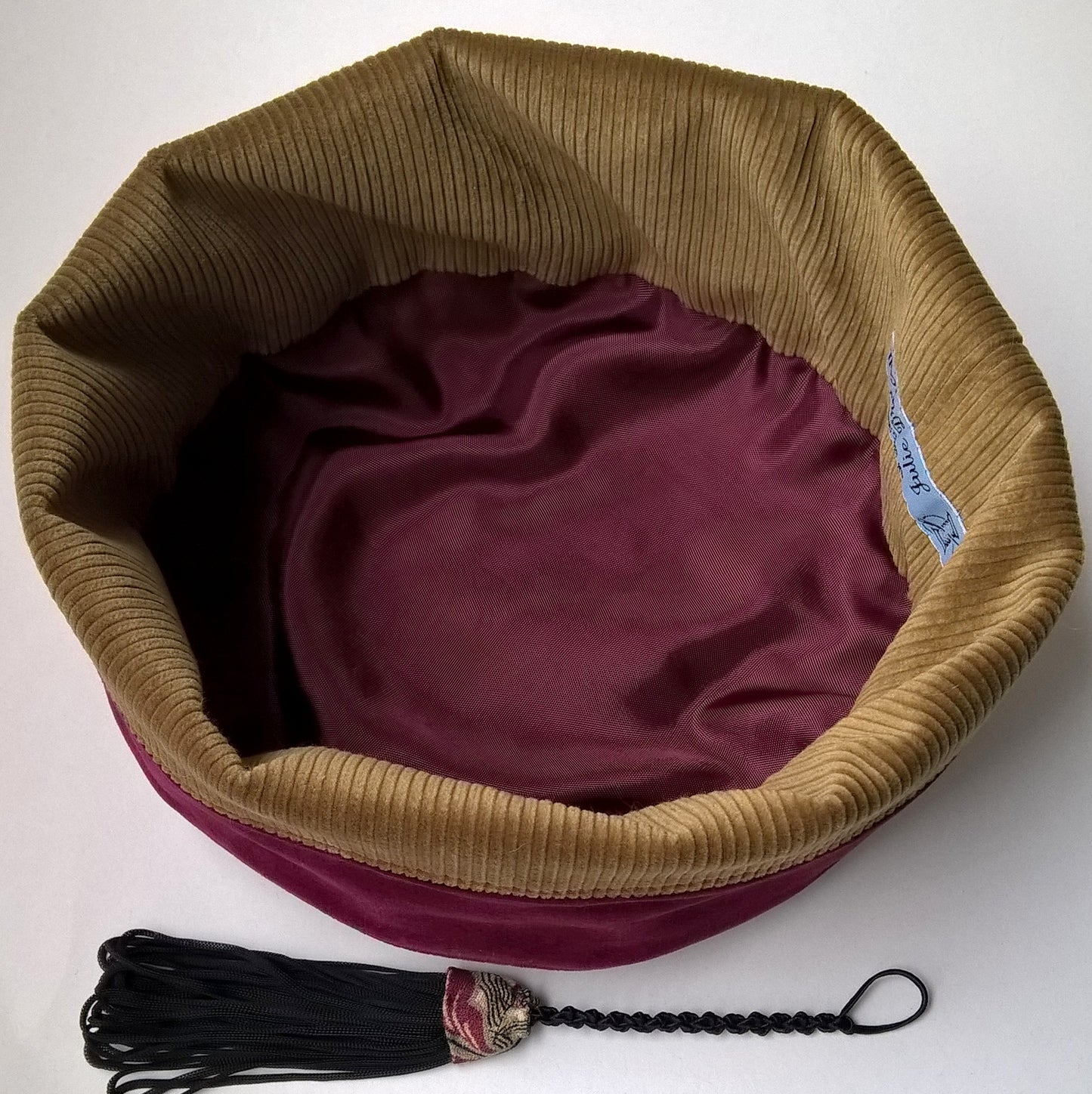 Smoking cap has a soft corduroy and burgundy satin lining