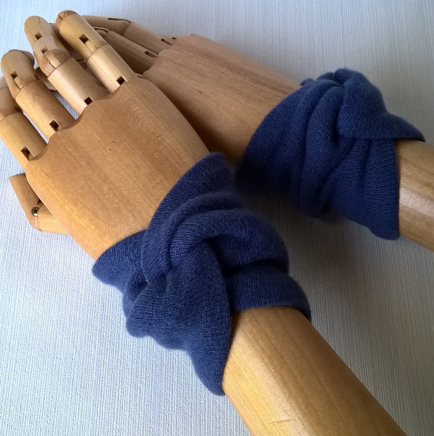 Handmade cashmere wrist warmers cover the pulse points to raise body temperature, leaving the hands free for performing tasks