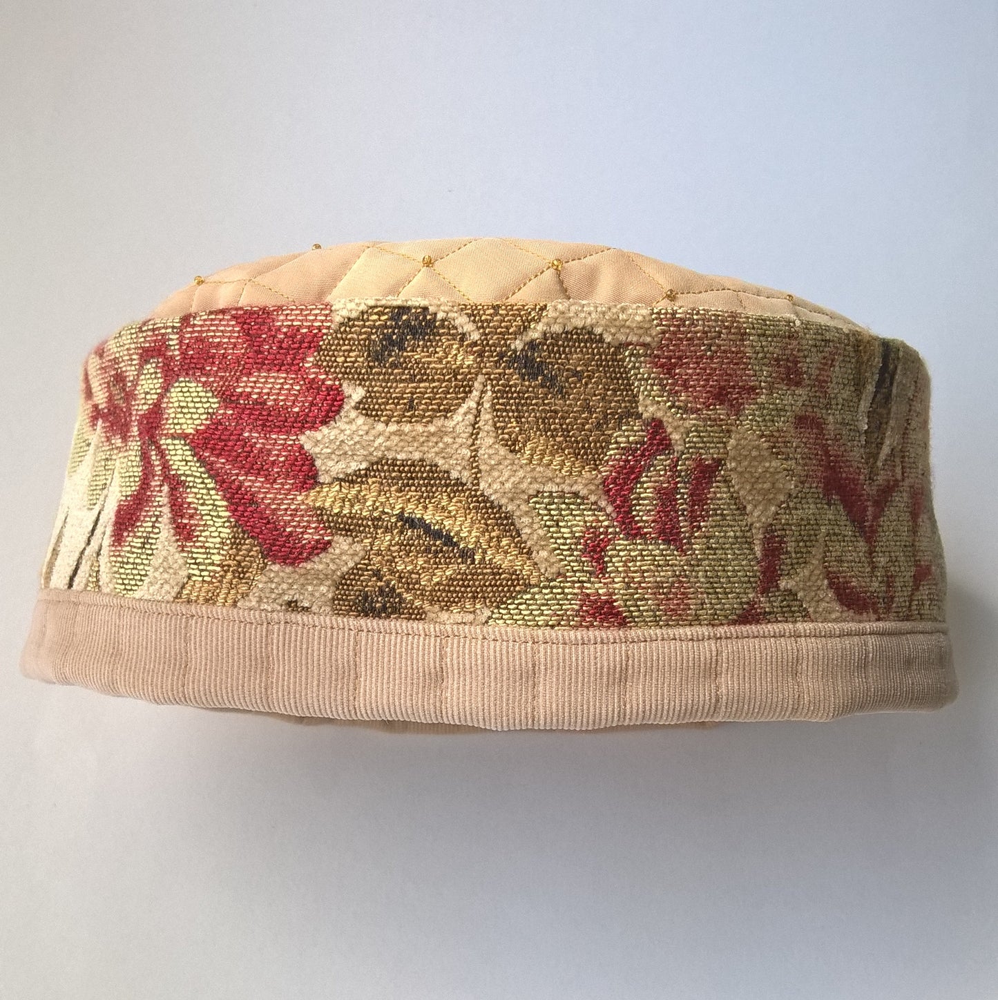 Tapestry brimless indoor hat embellished with beading and quilted for warmth. 