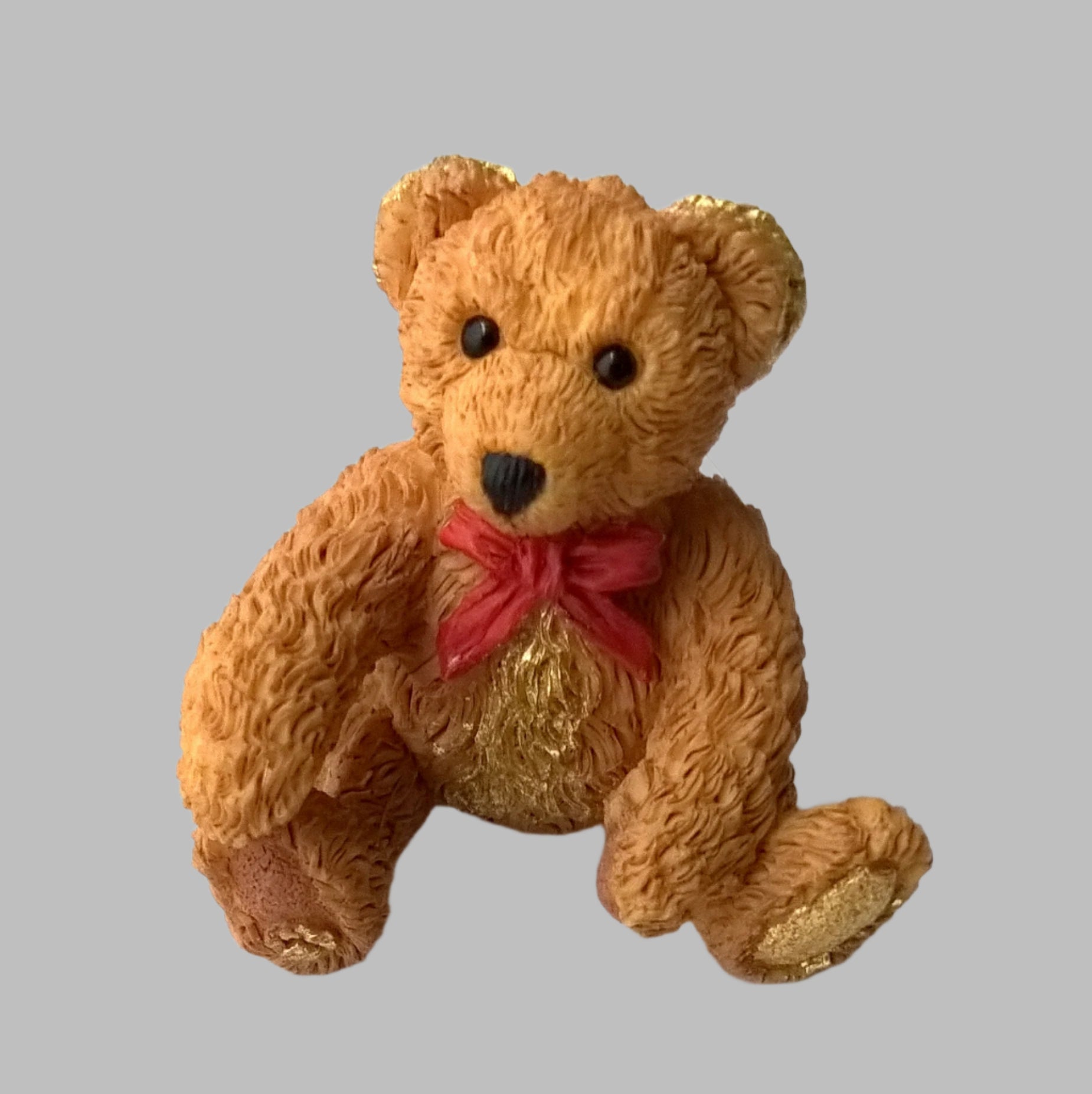 Vintage miniature ceramic tawny bear from 1995 with bright red bow and hand gilded with pure 24ct gold  in parts to make it a unique one-off.  