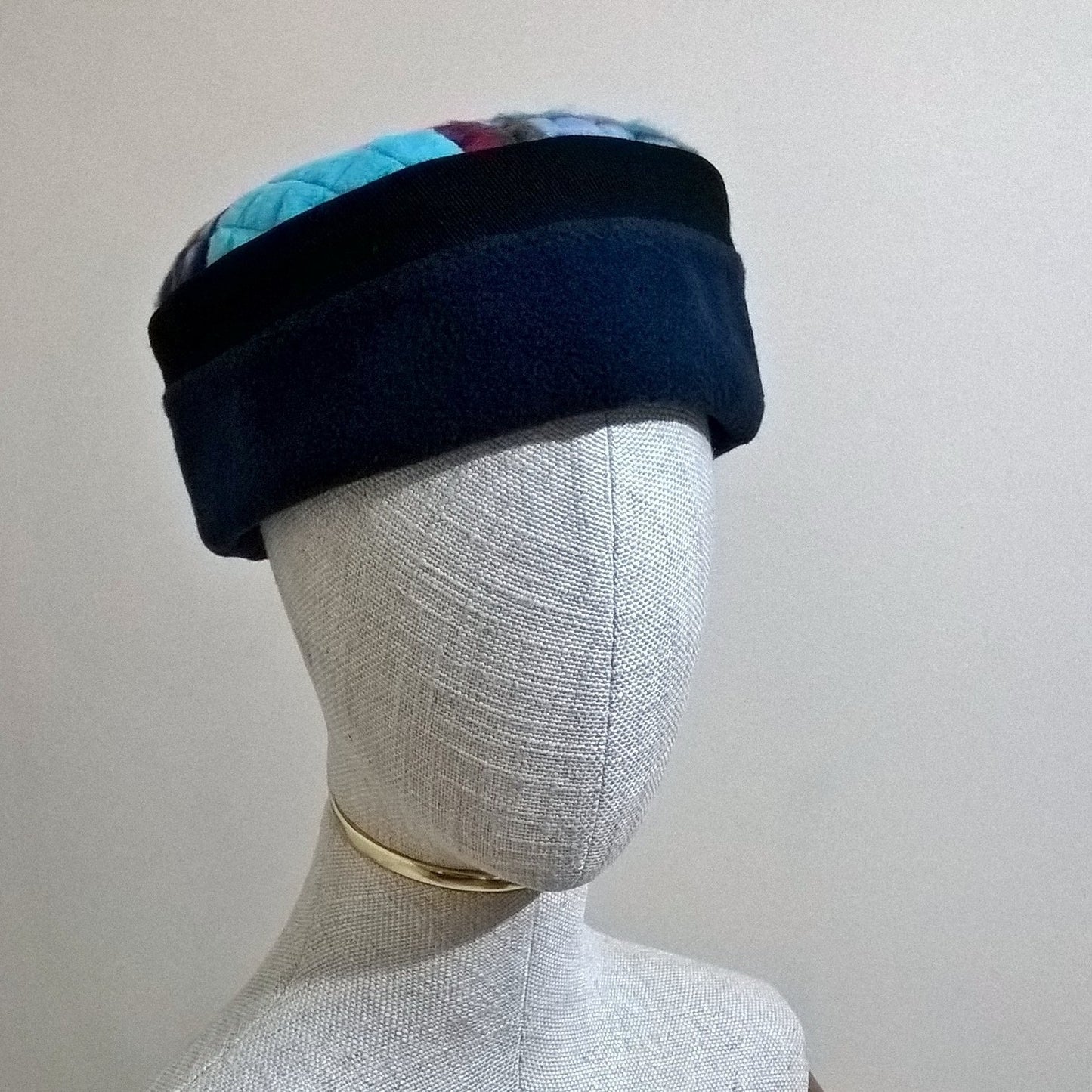 Navy and turquoise patchwork fleece pillbox shaped hat